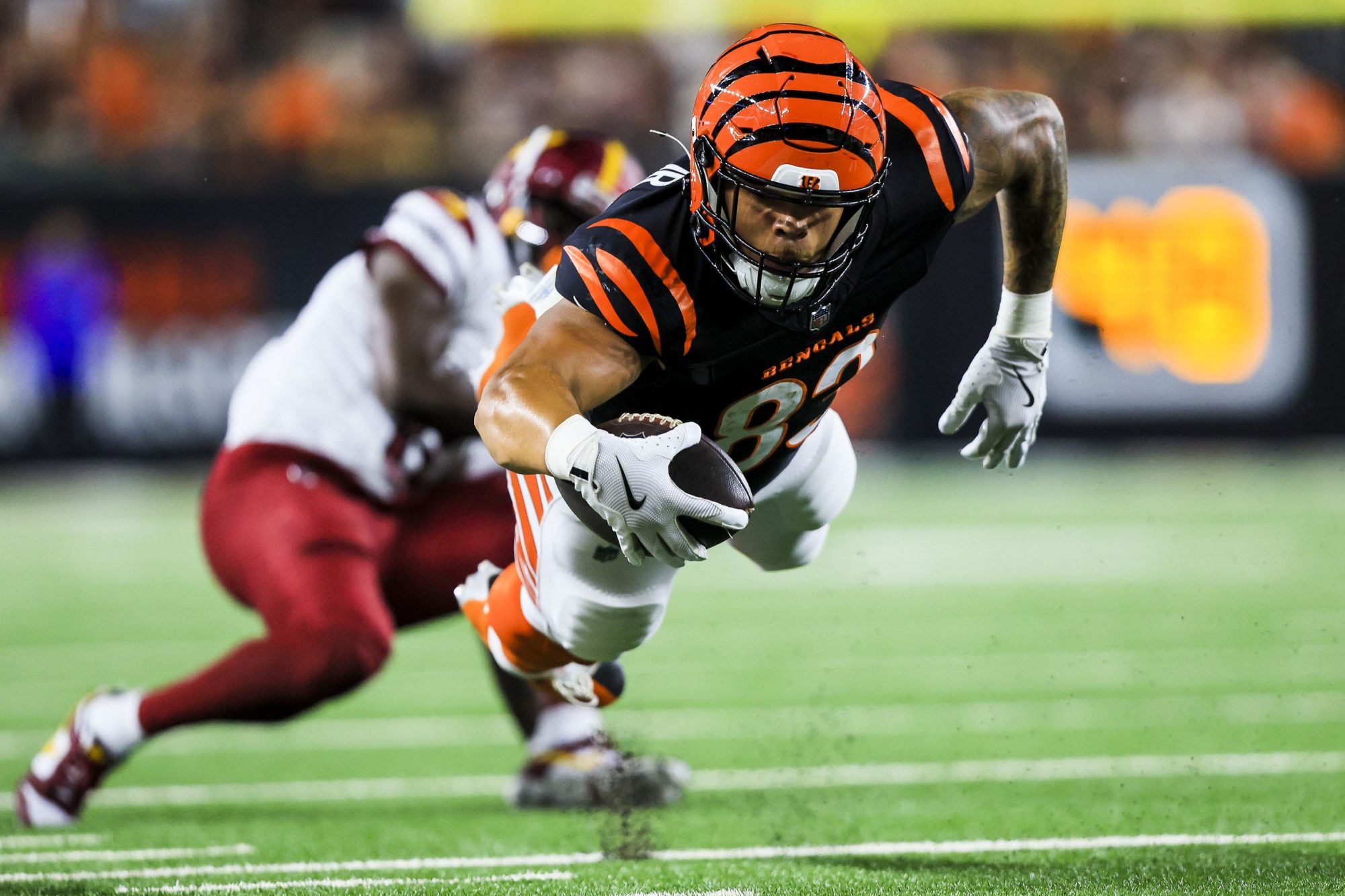 Sep 23, 2024; Cincinnati, Ohio, USA; Cincinnati Bengals tight end Erick All Jr. (83) advances the ball against the Washington Commanders in the first half at Paycor Stadium.