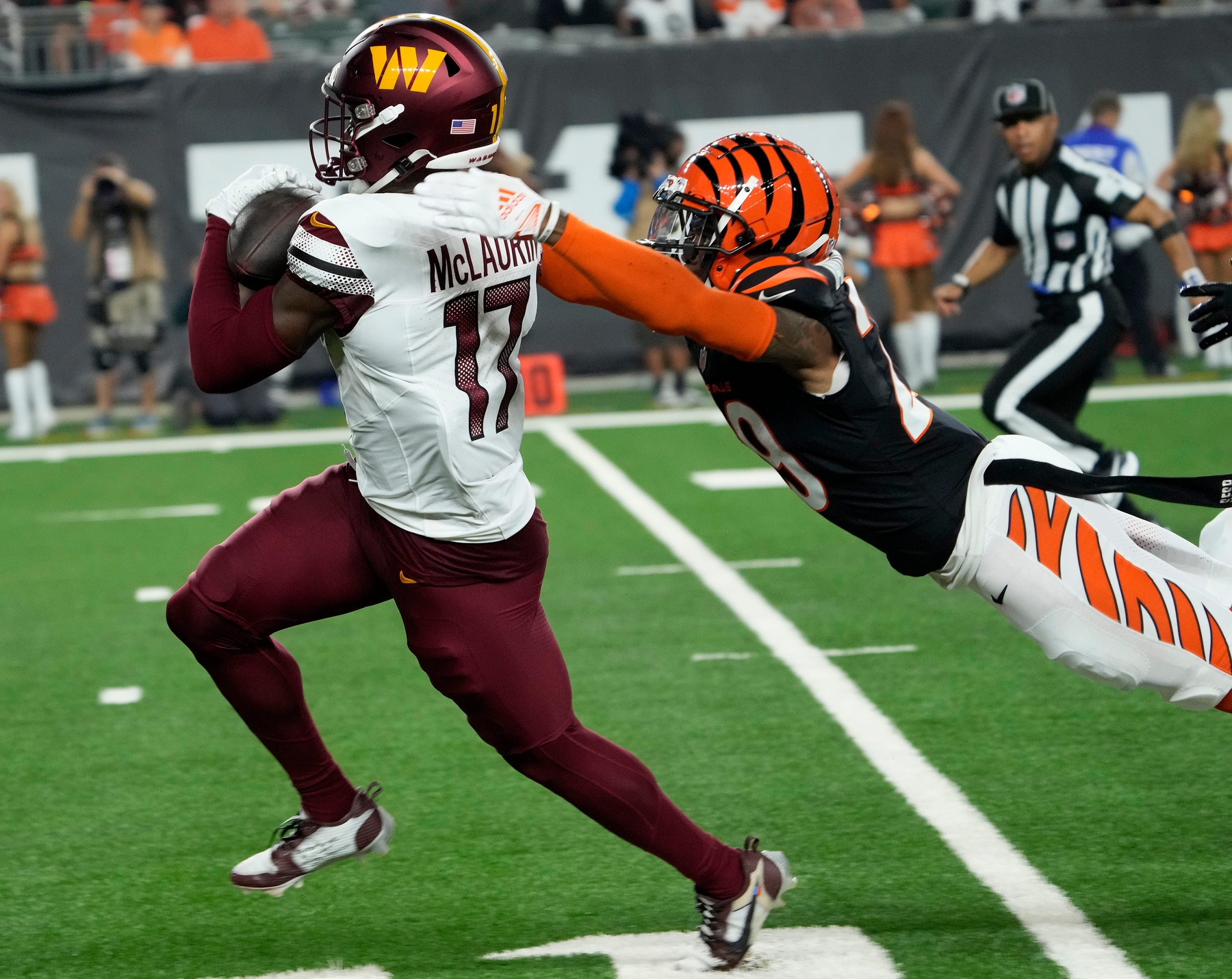 Washington Commanders wide receiver Terry McLaurin (17) runs toward the end zone as Cincinnati Bengals cornerback Cam Taylor-Britt (29) makes the tackle in the 2nd quarter Monday, September 23, 2024 at Paycor Stadium.