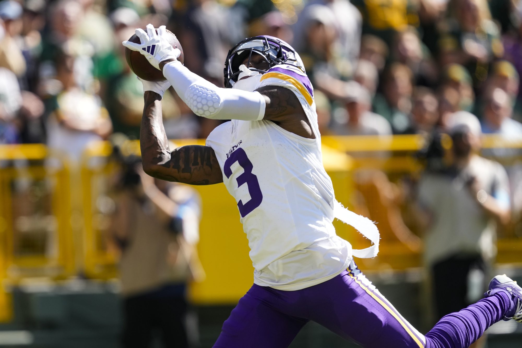 Sep 29, 2024; Green Bay, Wisconsin, USA; Minnesota Vikings wide receiver Jordan Addison (3) catches a pass to score a touchdown during the first quarter against the Green Bay Packers at Lambeau Field.