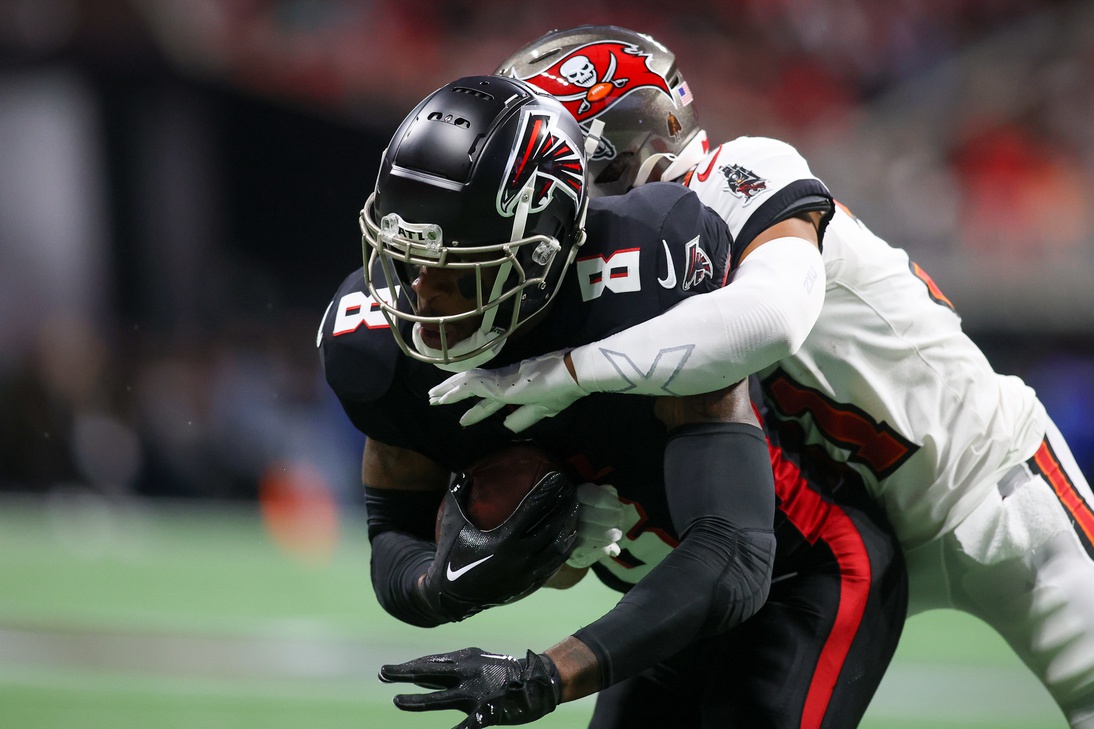 Dec 10, 2023; Atlanta, Georgia, USA; Atlanta Falcons tight end Kyle Pitts (8) is tackled by Tampa Bay Buccaneers cornerback Carlton Davis III (24) in the first half at Mercedes-Benz Stadium.