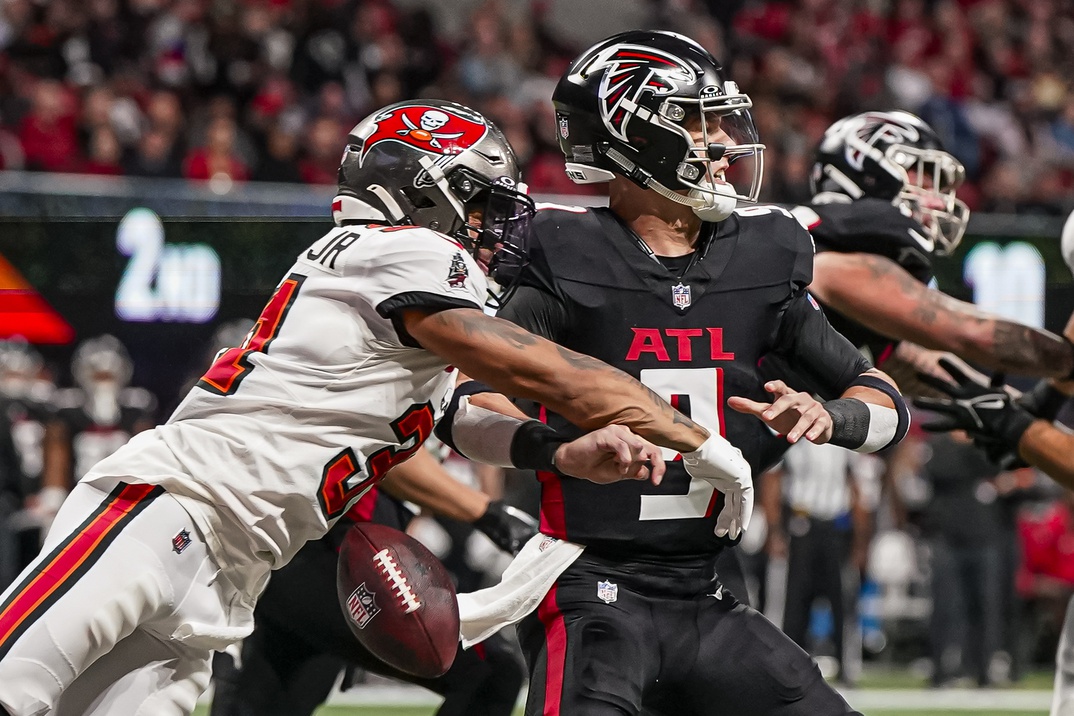 Dec 10, 2023; Atlanta, Georgia, USA; Tampa Bay Buccaneers safety Antoine Winfield Jr. (31) knocks the ball out of the hand of Atlanta Falcons quarterback Desmond Ridder (9) leading to a safety during the first half at Mercedes-Benz Stadium.