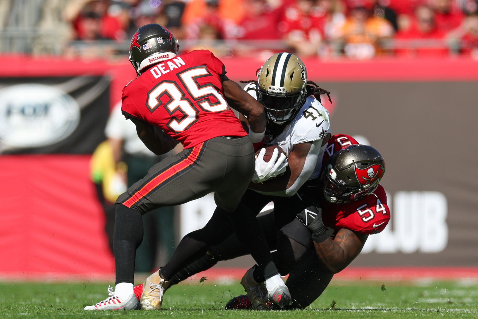 Dec 31, 2023; Tampa, Florida, USA; New Orleans Saints running back Alvin Kamara (41) is brought down by Tampa Bay Buccaneers linebacker Lavonte David (54) in the first quarter at Raymond James Stadium.