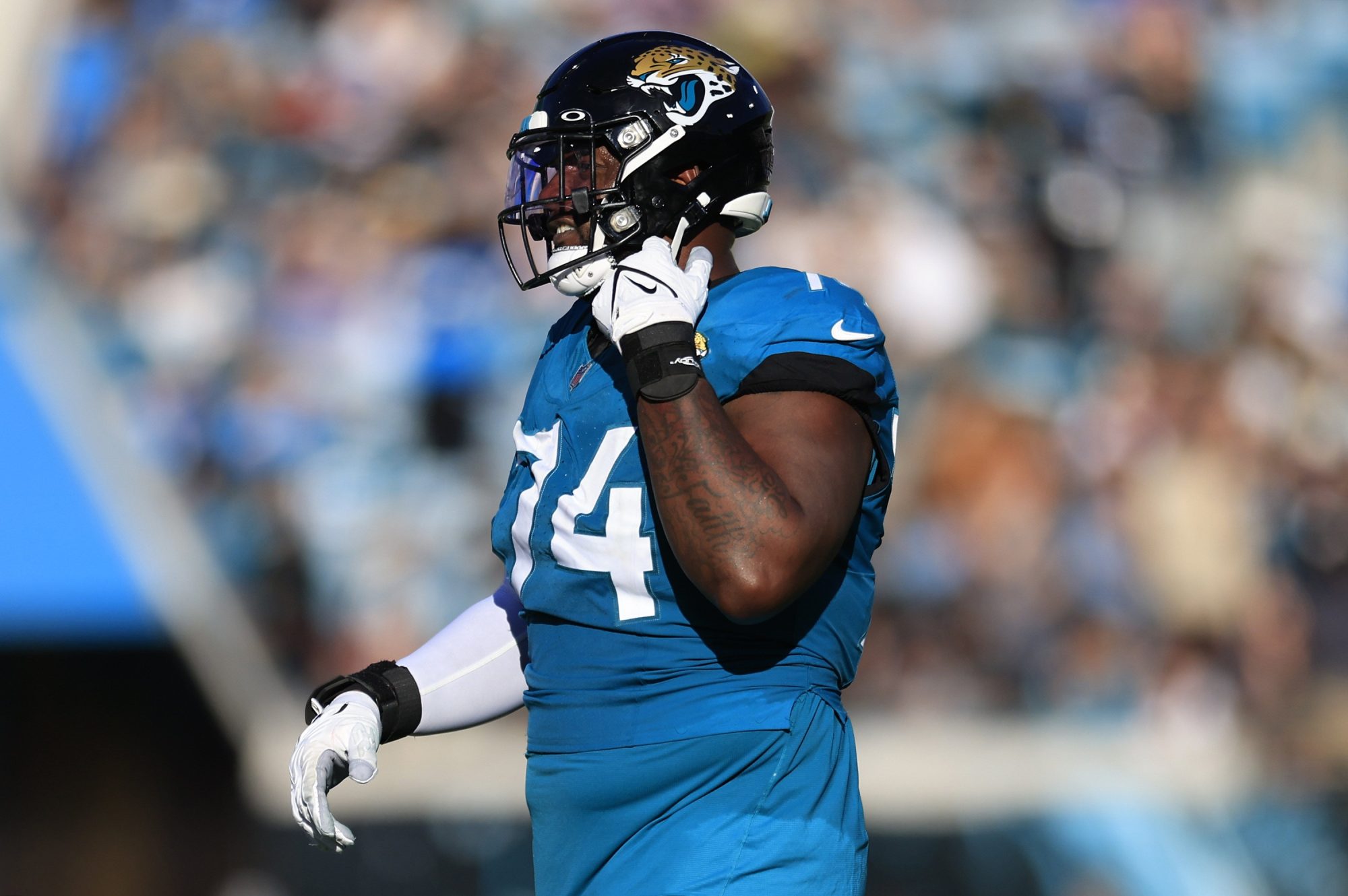 Jacksonville Jaguars offensive tackle Cam Robinson (74) walks off the field after being ejected for fighting with Carolina Panthers defensive tackle Derrick Brown (95), not shown, during the fourth quarter of a regular season NFL football matchup Sunday, Dec. 31, 2023 at EverBank Stadium in Jacksonville, Fla. The Jacksonville Jaguars blanked the Carolina Panthers 26-0.