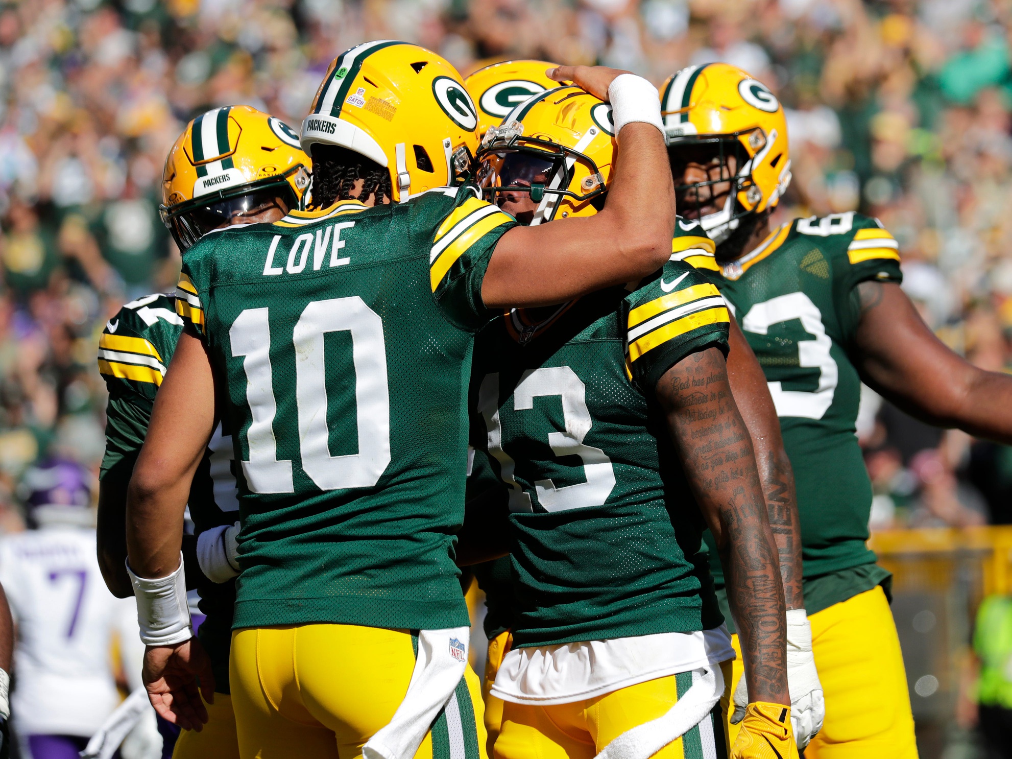 Green Bay Packers quarterback Jordan Love (10) and Dontayvion Wicks (13) celebrate a touchdown reception against the Minnesota Vikings during their football game Sunday, September 29, 2024, at Lambeau Field in Green Bay, Wisconsin.