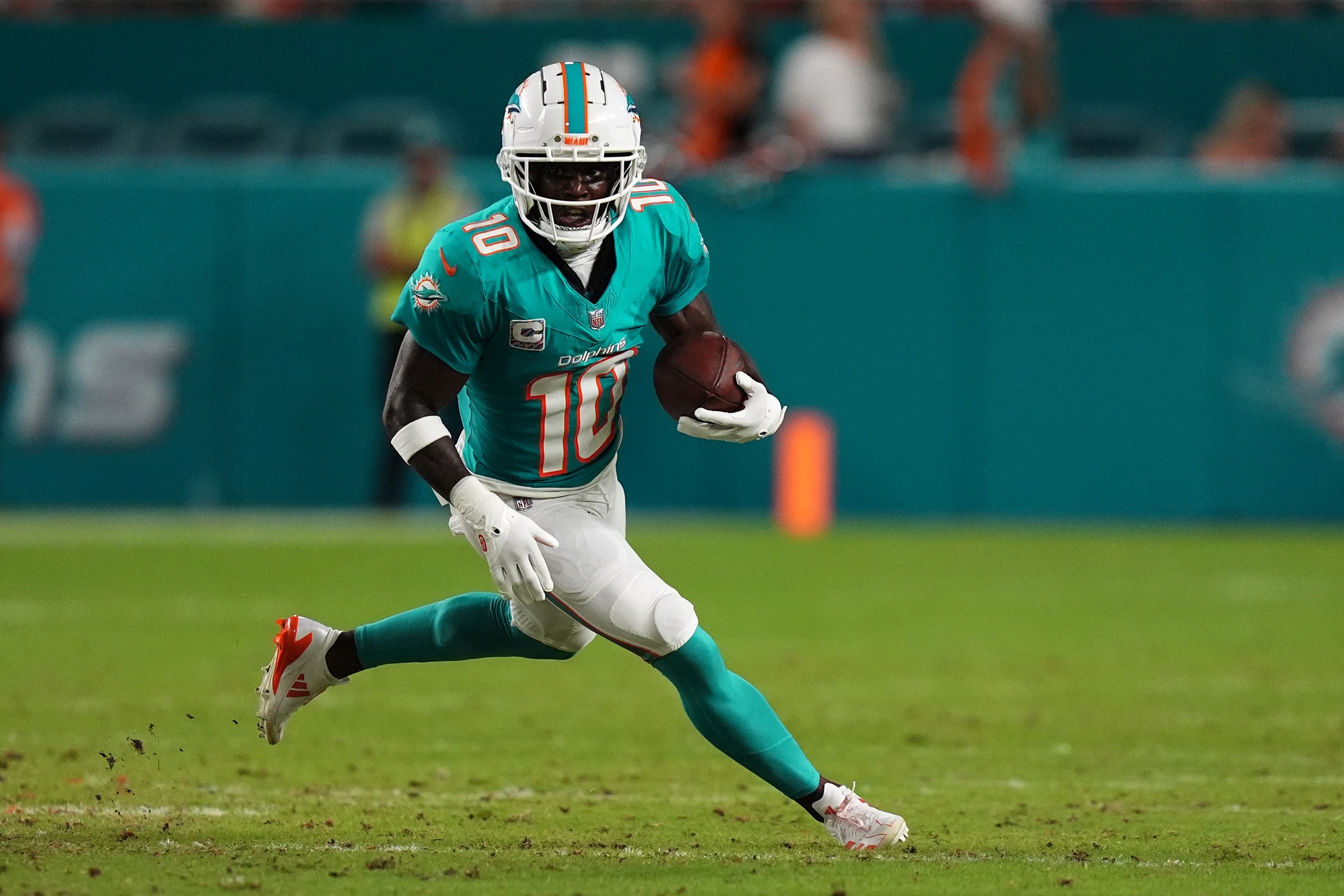 Sep 30, 2024; Miami Gardens, Florida, USA; Miami Dolphins wide receiver Tyreek Hill (10) runs with the ball during the first half against the Tennessee Titans at Hard Rock Stadium.