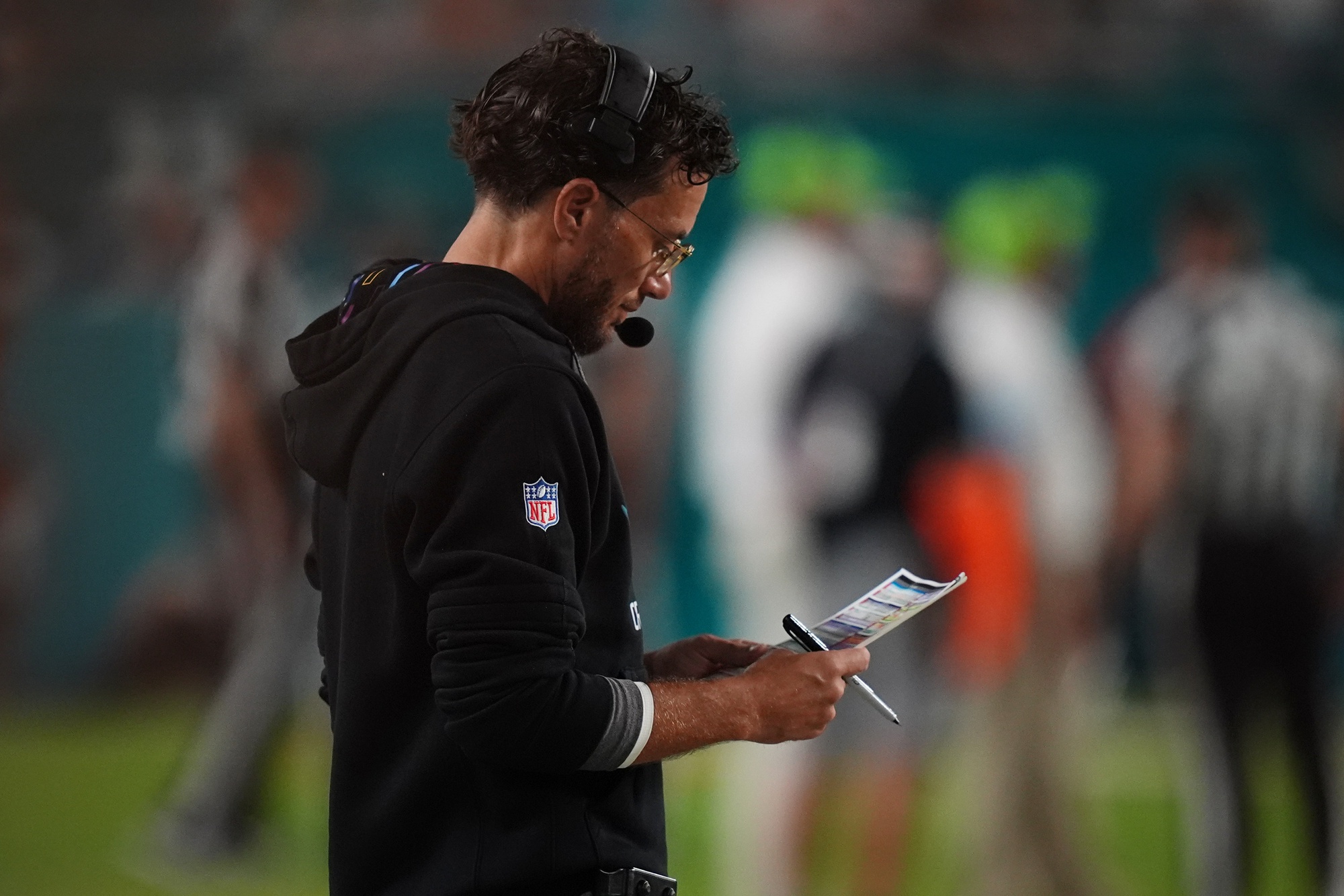 Sep 30, 2024; Miami Gardens, Florida, USA; Miami Dolphins head coach Mike McDaniel looks over his play card during the second half against the Tennessee Titans at Hard Rock Stadium.