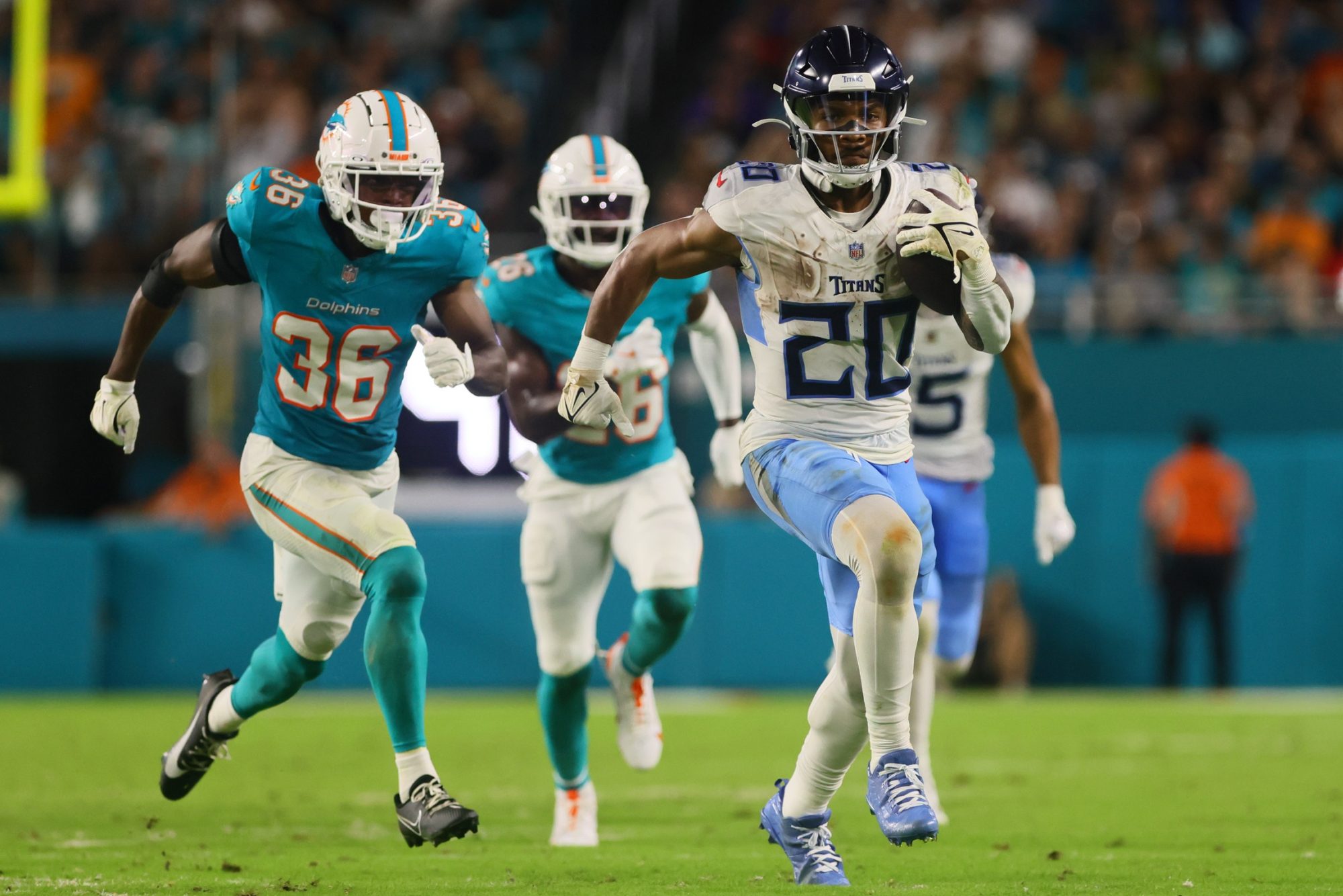 Sep 30, 2024; Miami Gardens, Florida, USA; Tennessee Titans running back Tony Pollard (20) runs with the football against the Miami Dolphins during the third quarter at Hard Rock Stadium.