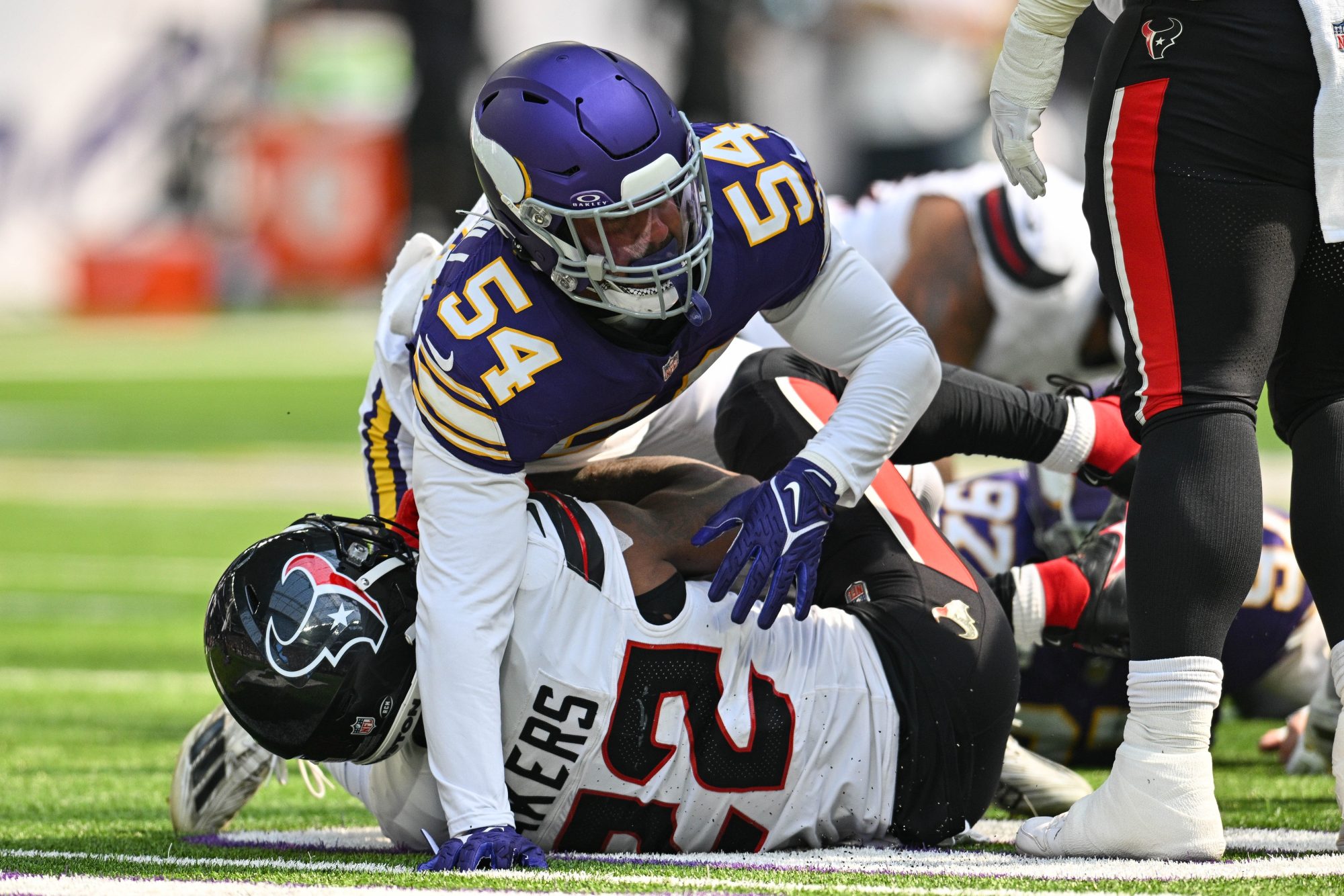 Sep 22, 2024; Minneapolis, Minnesota, USA; Minnesota Vikings linebacker Kamu Grugier-Hill (54) makes the tackle of Houston Texans running back Cam Akers (22) during the game at U.S. Bank Stadium.