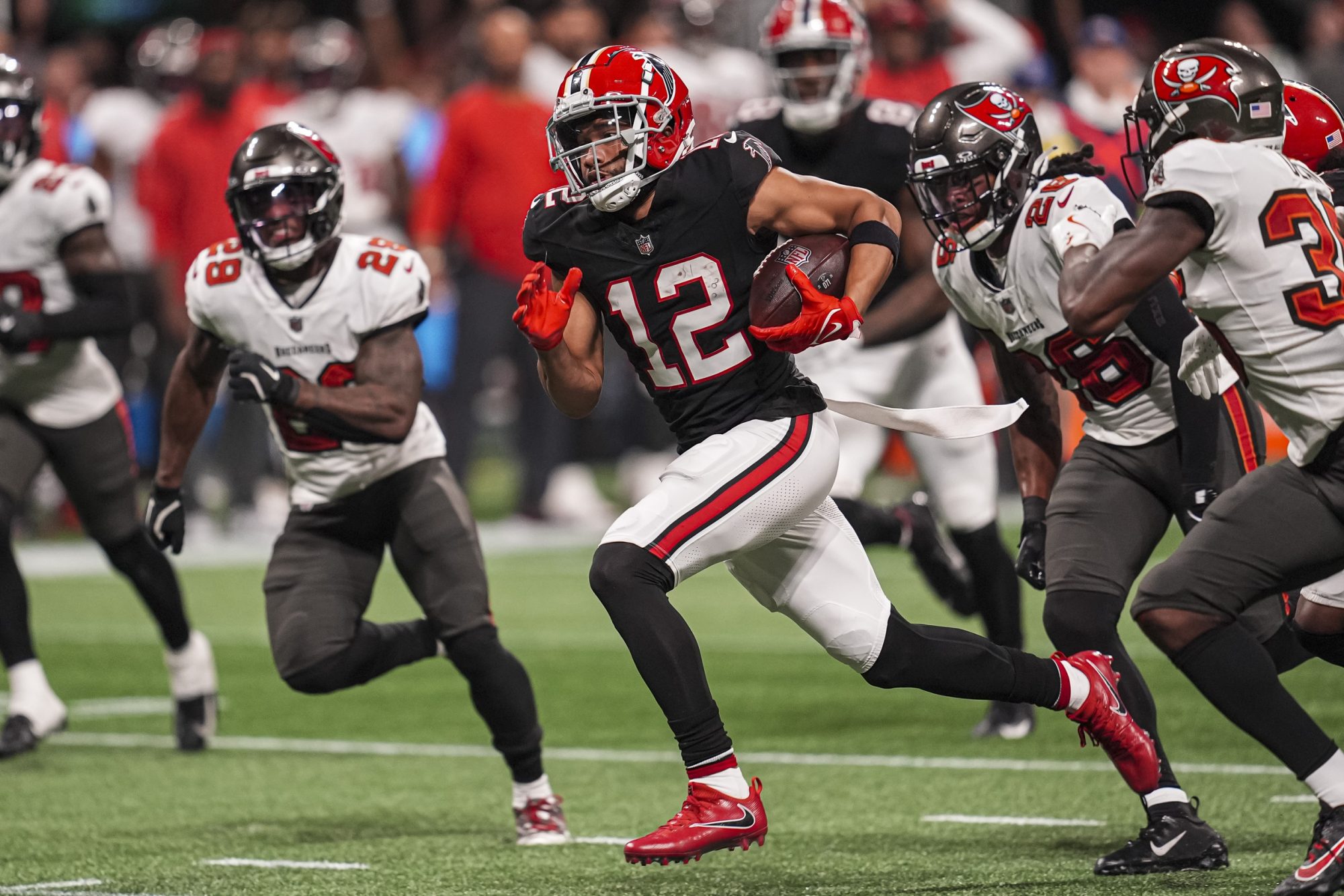 Oct 3, 2024; Atlanta, Georgia, USA; Atlanta Falcons wide receiver KhaDarel Hodge (12) runs for the game winning touchdown against the Tampa Bay Buccaneers in overtime at Mercedes-Benz Stadium.