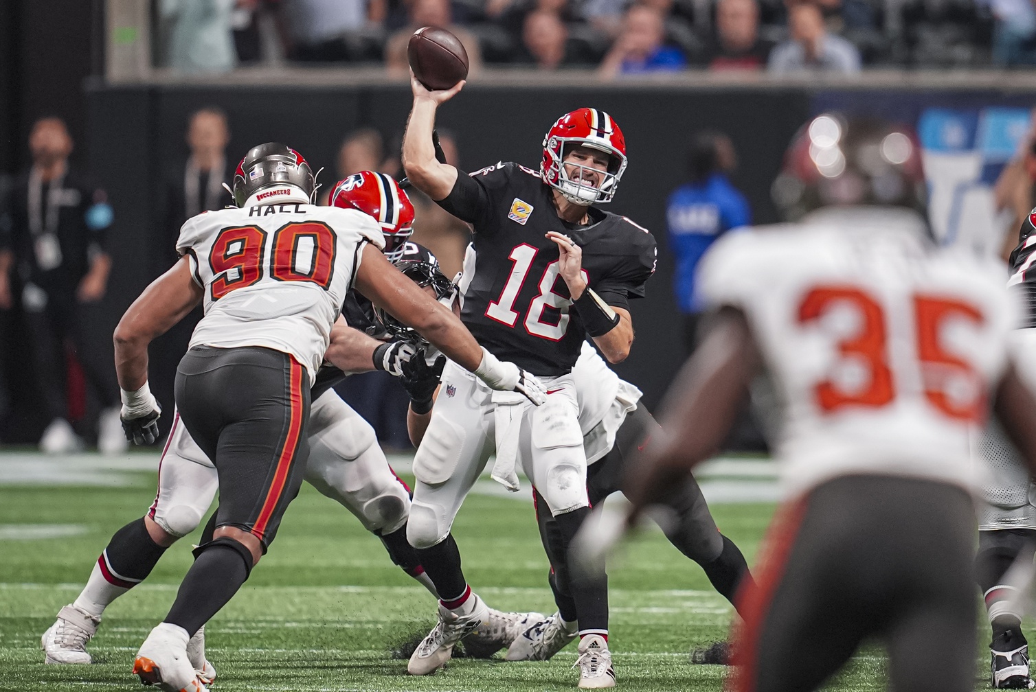 Oct 3, 2024; Atlanta, Georgia, USA; Atlanta Falcons quarterback Kirk Cousins (18) passes the ball against the Tampa Bay Buccaneers in the second half at Mercedes-Benz Stadium.