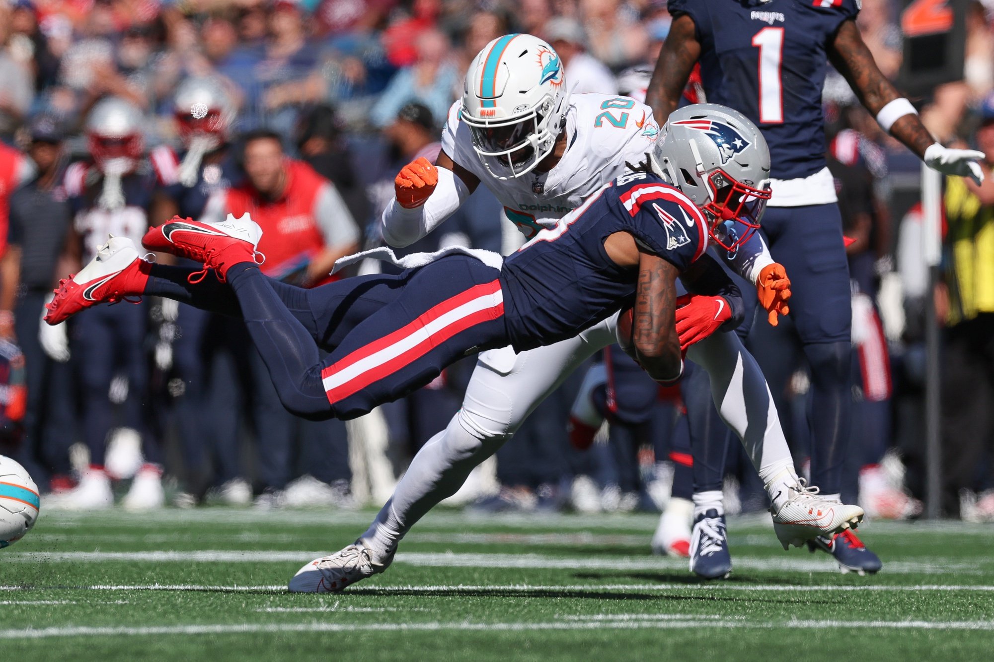 Oct 6, 2024; Foxborough, Massachusetts, USA; New England Patriots wide receiver DeMario Douglas (3) dives during the first half against the Miami Dolphins at Gillette Stadium.