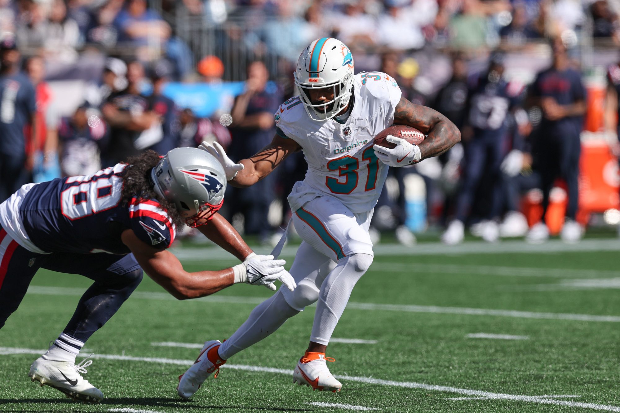 Oct 6, 2024; Foxborough, Massachusetts, USA; Miami Dolphins running back Raheem Mostert (31) runs the ball during the first half against the New England Patriots at Gillette Stadium.