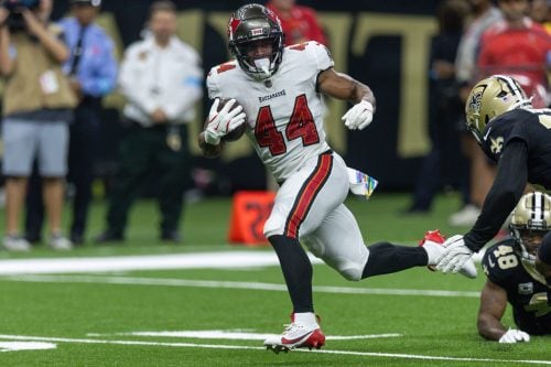 Oct 13, 2024; New Orleans, Louisiana, USA; Tampa Bay Buccaneers running back Sean Tucker (44) runs away from the tackle of New Orleans Saints safety J.T. Gray (48) during the first half at Caesars Superdome.