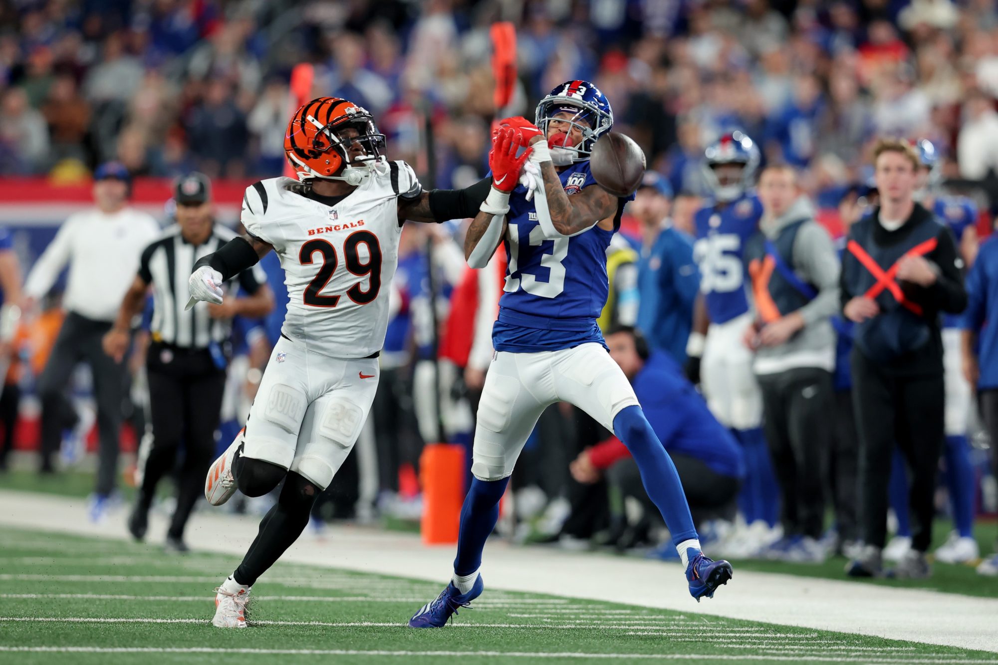 Oct 13, 2024; East Rutherford, New Jersey, USA; Cincinnati Bengals cornerback Cam Taylor-Britt (29) breaks up a pass intended for New York Giants wide receiver Jalin Hyatt (13) during the fourth quarter at MetLife Stadium.