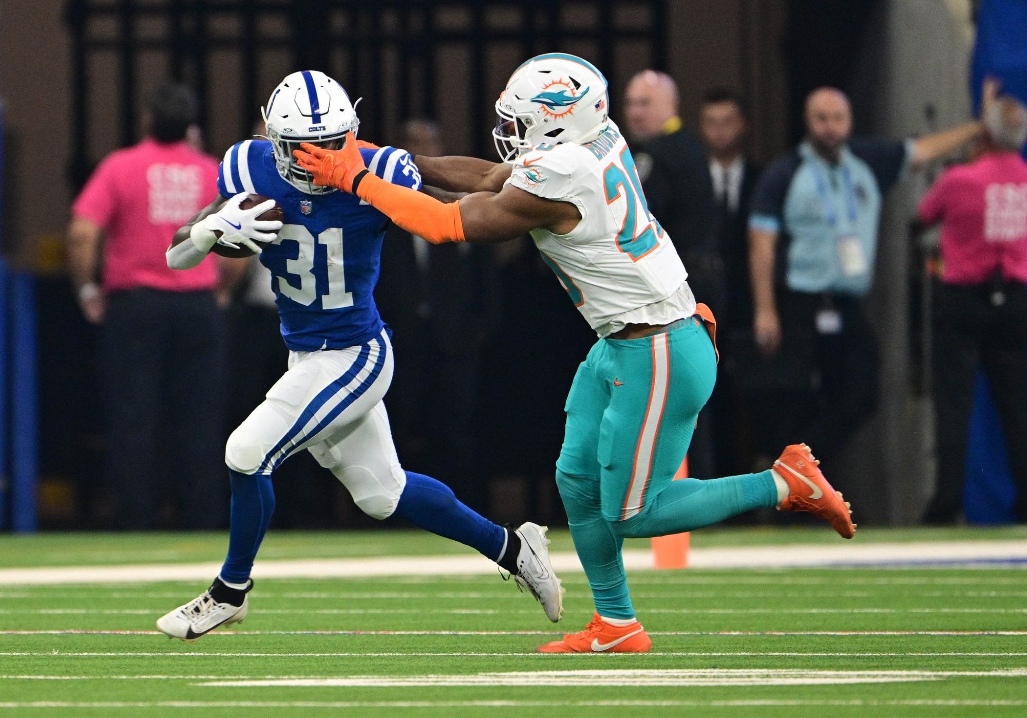 Oct 20, 2024; Indianapolis, Indiana, USA; Indianapolis Colts running back Tyler Goodson (31) attempts to evade tackle by Miami Dolphins linebacker Jordyn Brooks (20) during the first quarter at Lucas Oil Stadium.