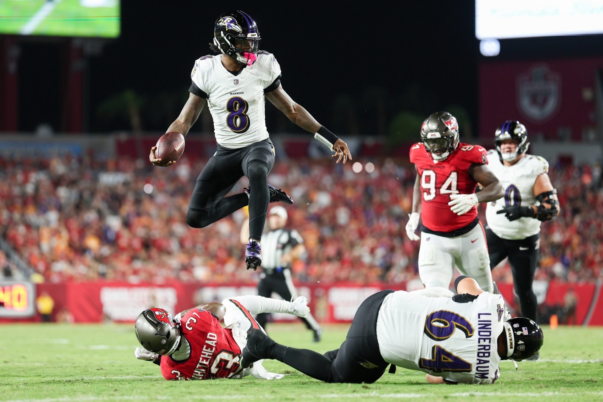 Oct 21, 2024; Tampa, Florida, USA; Baltimore Ravens quarterback Lamar Jackson (8) runs with the ball against the Tampa Bay Buccaneers in the second quarter at Raymond James Stadium.