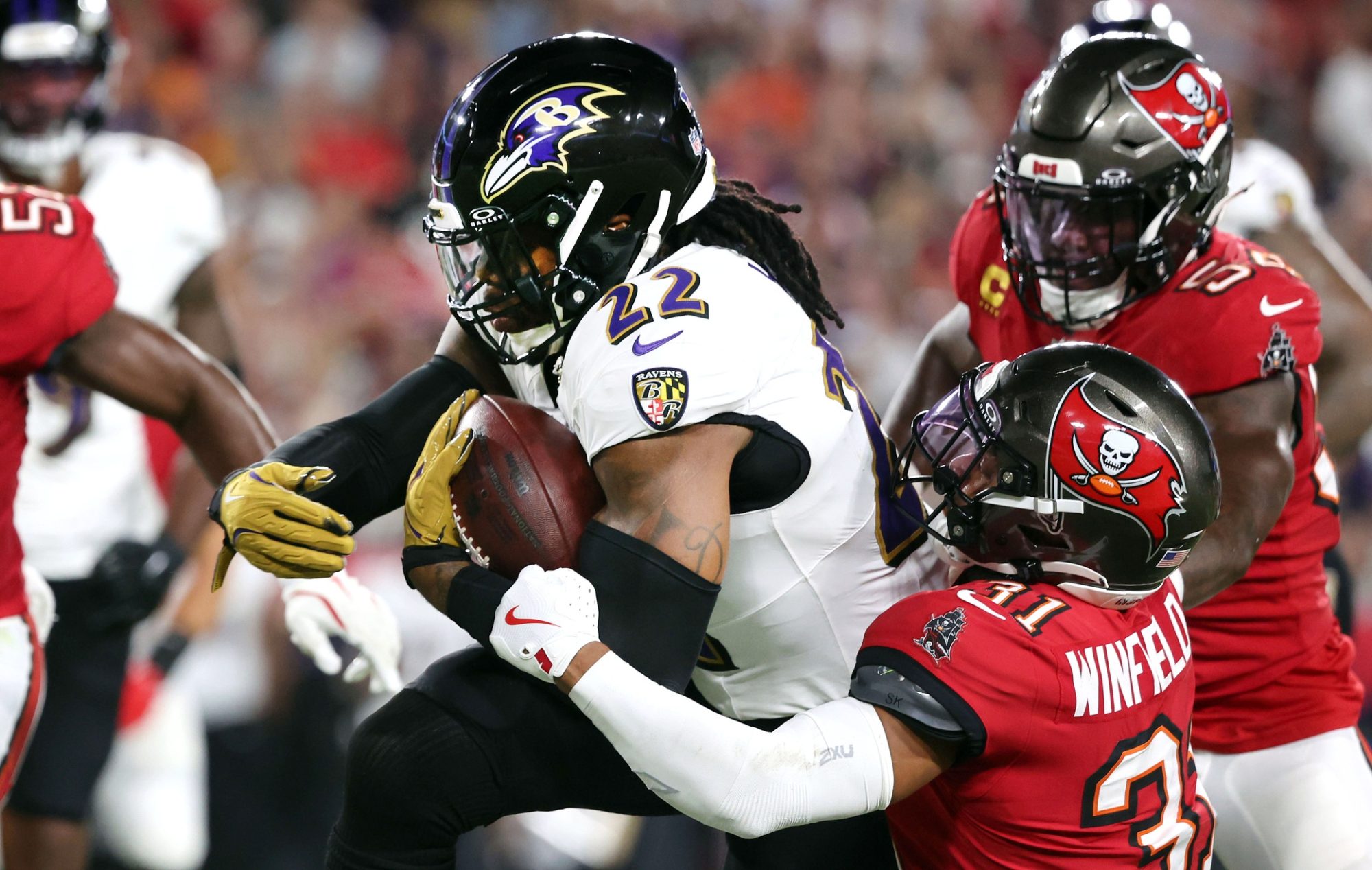 Oct 21, 2024; Tampa, Florida, USA; Baltimore Ravens running back Derrick Henry (22) runs with the ball as Tampa Bay Buccaneers safety Antoine Winfield Jr. (31) defends during the first half at Raymond James Stadium.