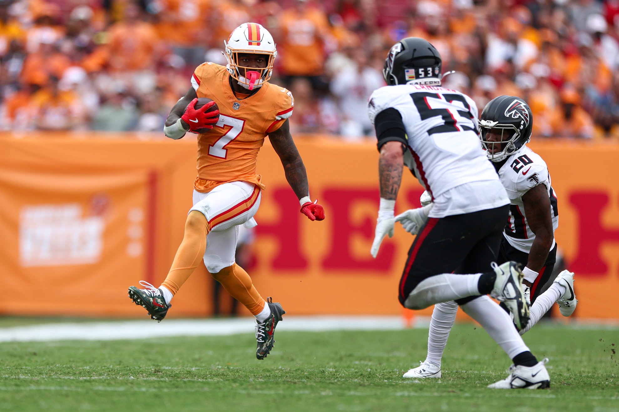 Oct 27, 2024; Tampa, Florida, USA; Tampa Bay Buccaneers running back Bucky Irving (7) runs with the ball against the Atlanta Falcons in the third quarter at Raymond James Stadium.