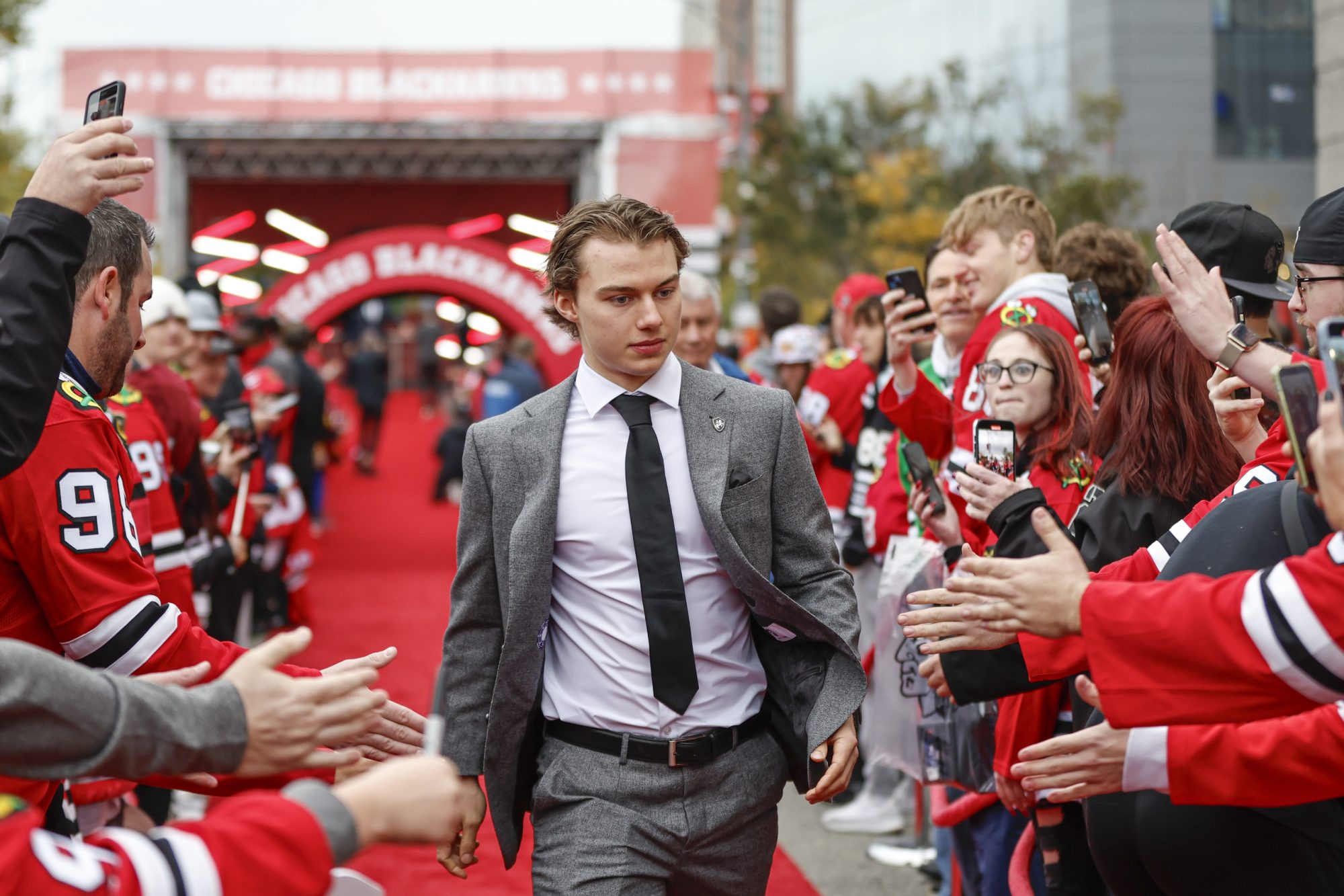 Oct 21, 2023; Chicago, Illinois, USA; Chicago Blackhawks center Connor Bedard (98) walks on the red carpet before the Blackhawks home opener against the Vegas Golden Knights at United Center.