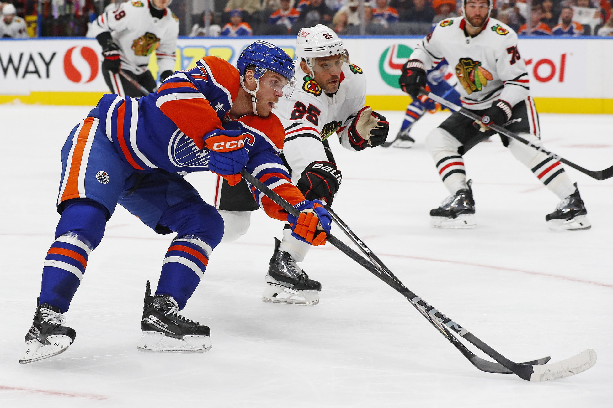 Oct 12, 2024; Edmonton, Alberta, CAN; Edmonton Oilers forward Connor McDavid (97) tries to carry the puck around Chicago Blackhawks defensemen Alec Martinez (25) during the first period at Rogers Place.