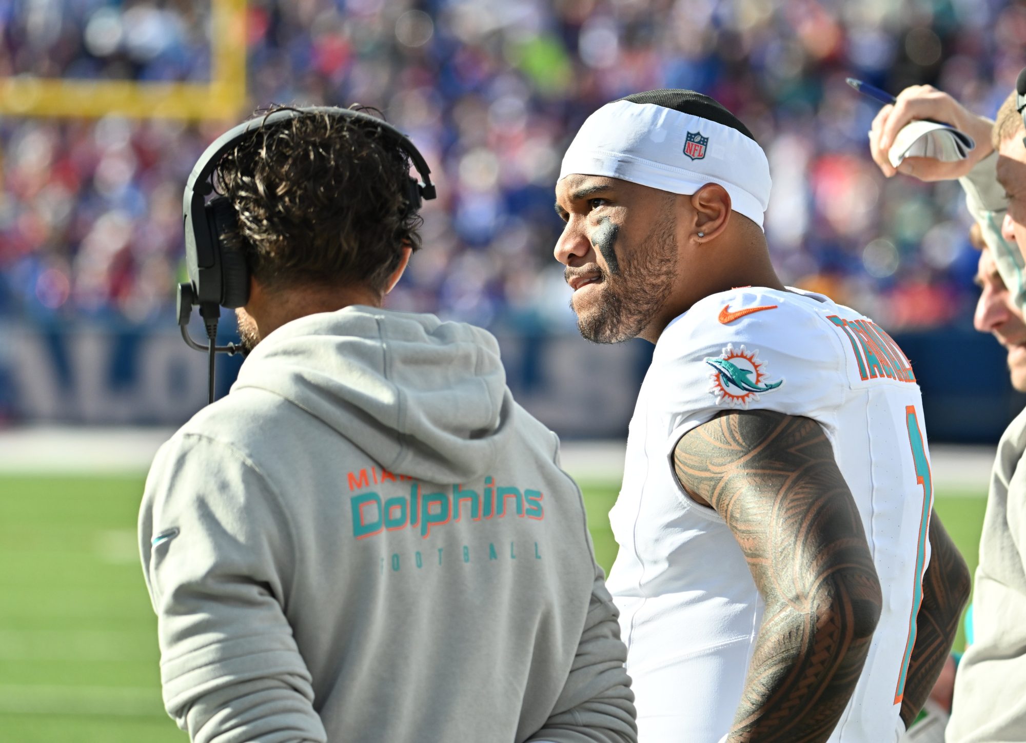 Nov 3, 2024; Orchard Park, New York, USA; Miami Dolphins quarterback Tua Tagovailoa (1) on the sidelines with head coach Mike McDaniel in the second quarter game against the Buffalo Bills at Highmark Stadium.