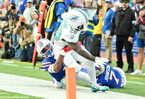 Nov 3, 2024; Orchard Park, New York, USA; Miami Dolphins running back De'Von Achane (28) is tackled short of the goal line by Buffalo Bills safety Damar Hamlin (3) in the fourth quarter at Highmark Stadium.