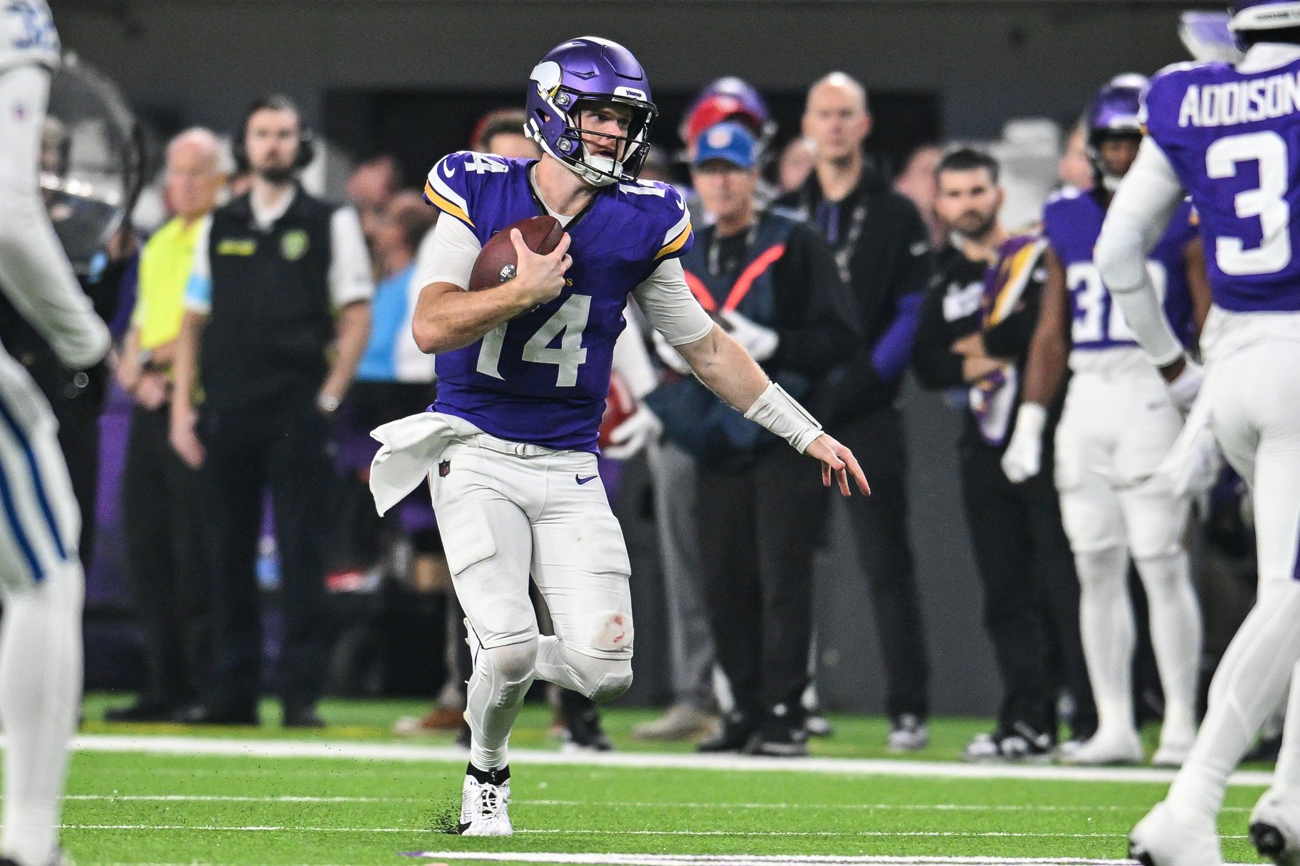 Nov 3, 2024; Minneapolis, Minnesota, USA; Minnesota Vikings quarterback Sam Darnold (14) scrambles with the ball against the Indianapolis Colts during the third quarter at U.S. Bank Stadium.