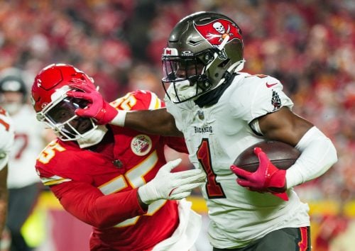 Nov 4, 2024; Kansas City, Missouri, USA; Tampa Bay Buccaneers running back Rachaad White (1) runs the ball against Kansas City Chiefs linebacker Joshua Uche (55) during the first half at GEHA Field at Arrowhead Stadium.