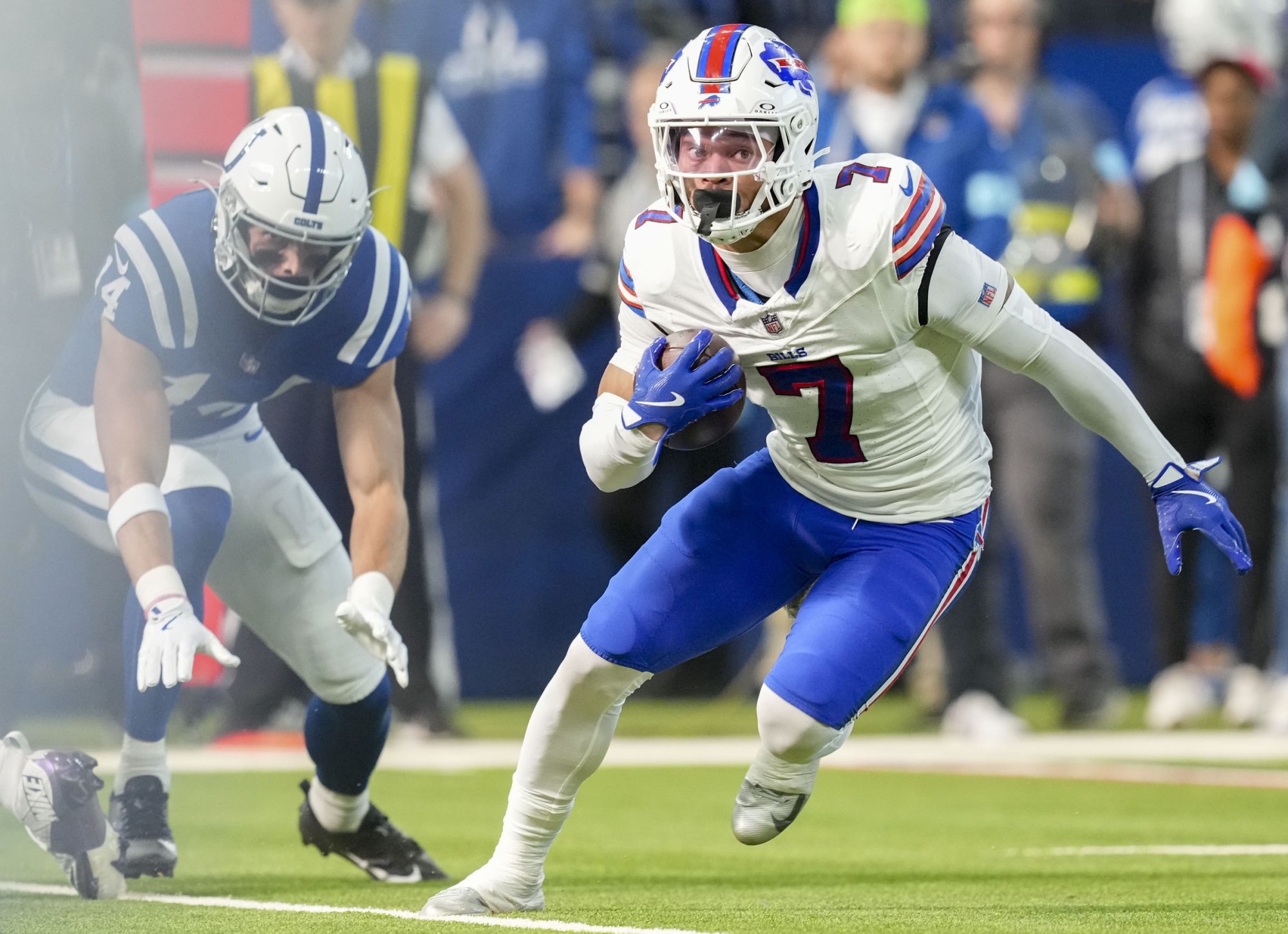 Nov 10, 2024; Indianapolis, Indiana, USA; Buffalo Bills cornerback Taron Johnson (7) rushes for a touchdown after intercepting the first pass of the game by Indianapolis Colts quarterback Joe Flacco (15) on Sunday, Nov. 10, 2024, during a game at Lucas Oil Stadium in Indianapolis.