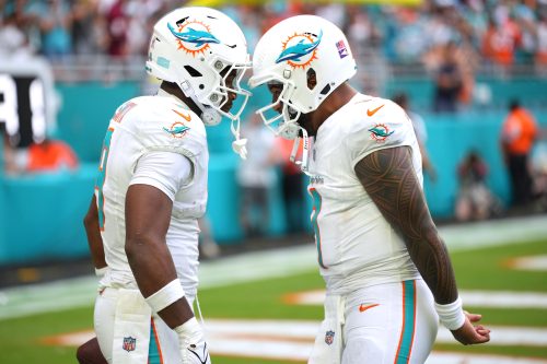 Nov 17, 2024; Miami Gardens, Florida, USA; Miami Dolphins tight end Jonnu Smith (9) celebrates a touchdown against the Las Vegas Raiders with quarterback Tua Tagovailoa (1) in the fourth quarter at Hard Rock Stadium.