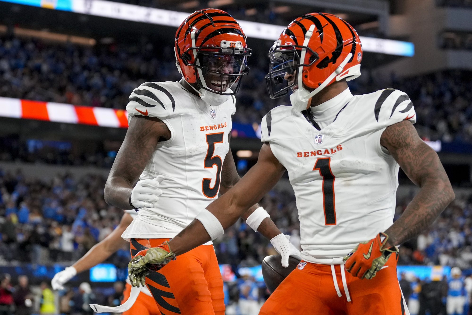 Nov 17, 2024; Inglewood, CA, USA; Cincinnati Bengals wide receivers Tee Higgins (5) and Ja'Marr Chase (1) celebrate a Higgins touchdown in the third quarter of the against the Los Angeles Chargers at SoFi Stadium.