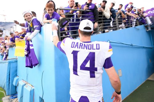 Nov 17, 2024; Nashville, Tennessee, USA; Minnesota Vikings quarterback Sam Darnold (14) hands his wrist bands to a fan as he leaves the field against the Tennessee Titans during the second half at Nissan Stadium.