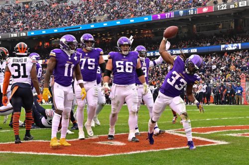 Nov 24, 2024; Chicago, Illinois, USA; Minnesota Vikings running back Aaron Jones (33) celebrates his rushing touchdown against the Chicago Bears during the third quarter at Soldier Field.