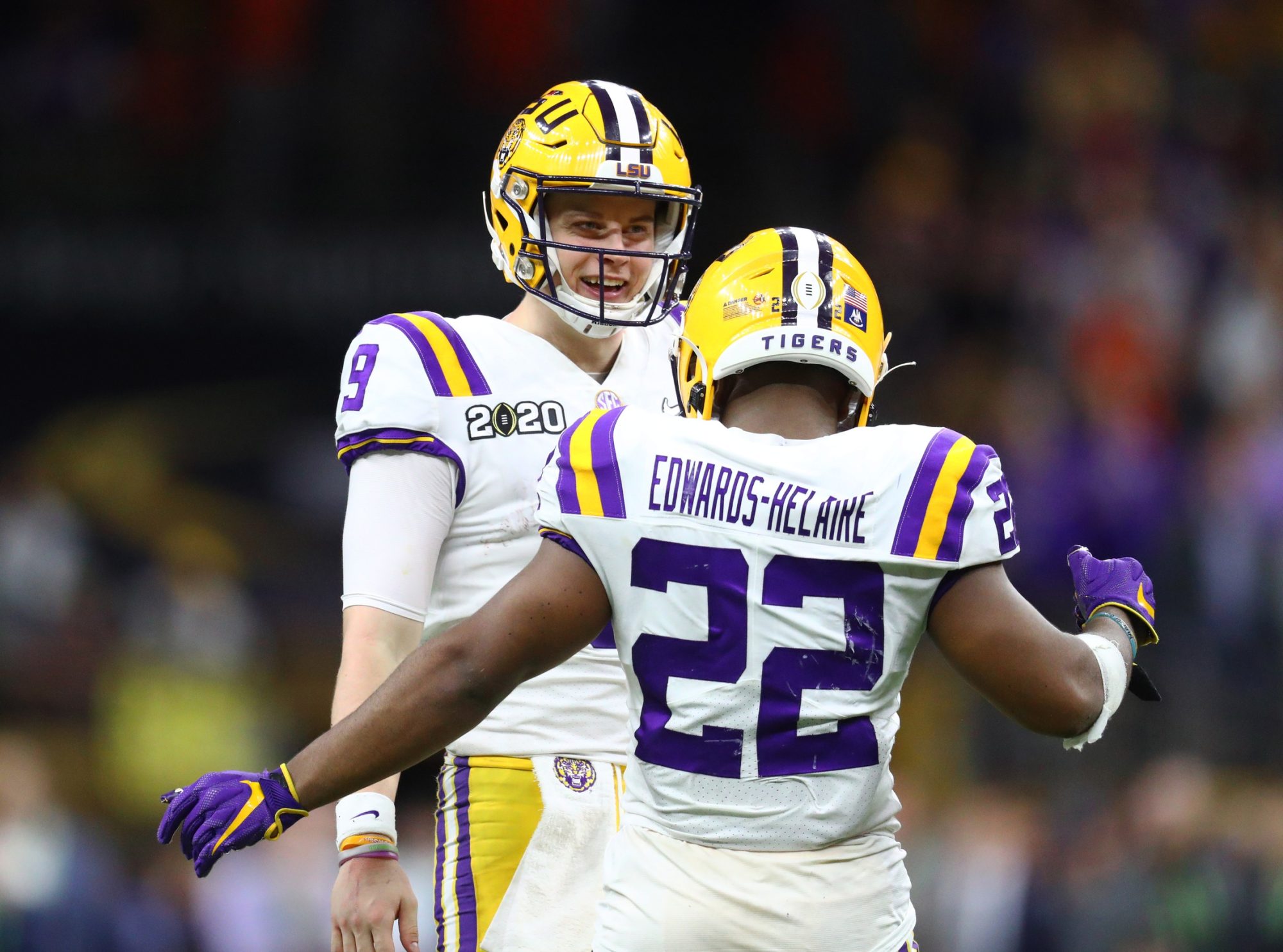 Jan 13, 2020; New Orleans, Louisiana, USA; LSU Tigers quarterback Joe Burrow (9) with running back Clyde Edwards-Helaire (22) against the Clemson Tigers in the College Football Playoff national championship game at Mercedes-Benz Superdome.