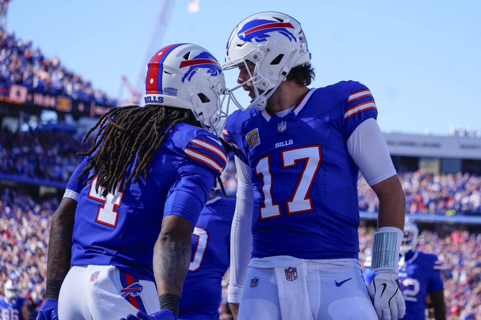 Oct 20, 2024; Orchard Park, New York, USA; Buffalo Bills quarterback Josh Allen (17) congratulates Buffalo Bills running back James Cook (4) for scoring a touchdown against the Tennessee Titans during the first half at Highmark Stadium.