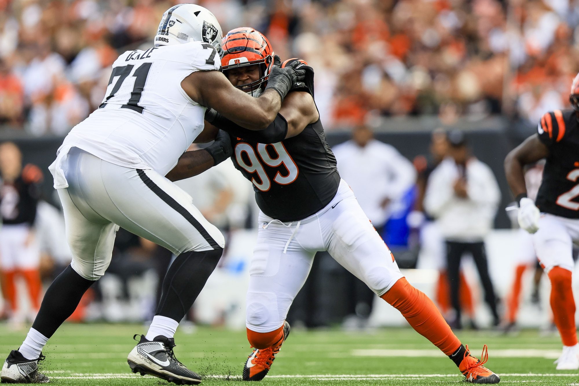 Nov 3, 2024; Cincinnati, Ohio, USA; Las Vegas Raiders offensive tackle DJ Glaze (71) pushes against Cincinnati Bengals defensive end Myles Murphy (99) in the second half at Paycor Stadium.