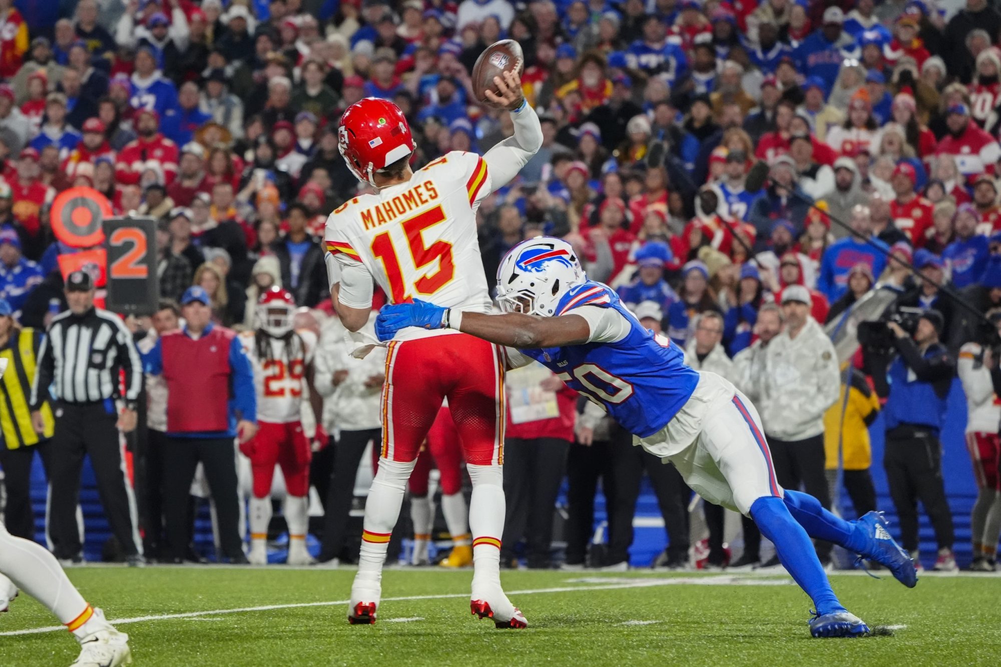 Nov 17, 2024; Orchard Park, New York, USA; Buffalo Bills defensive end Greg Rousseau (50) pressures Kansas City Chiefs quarterback Patrick Mahomes (15) while throwing the ball during the first half at Highmark Stadium.