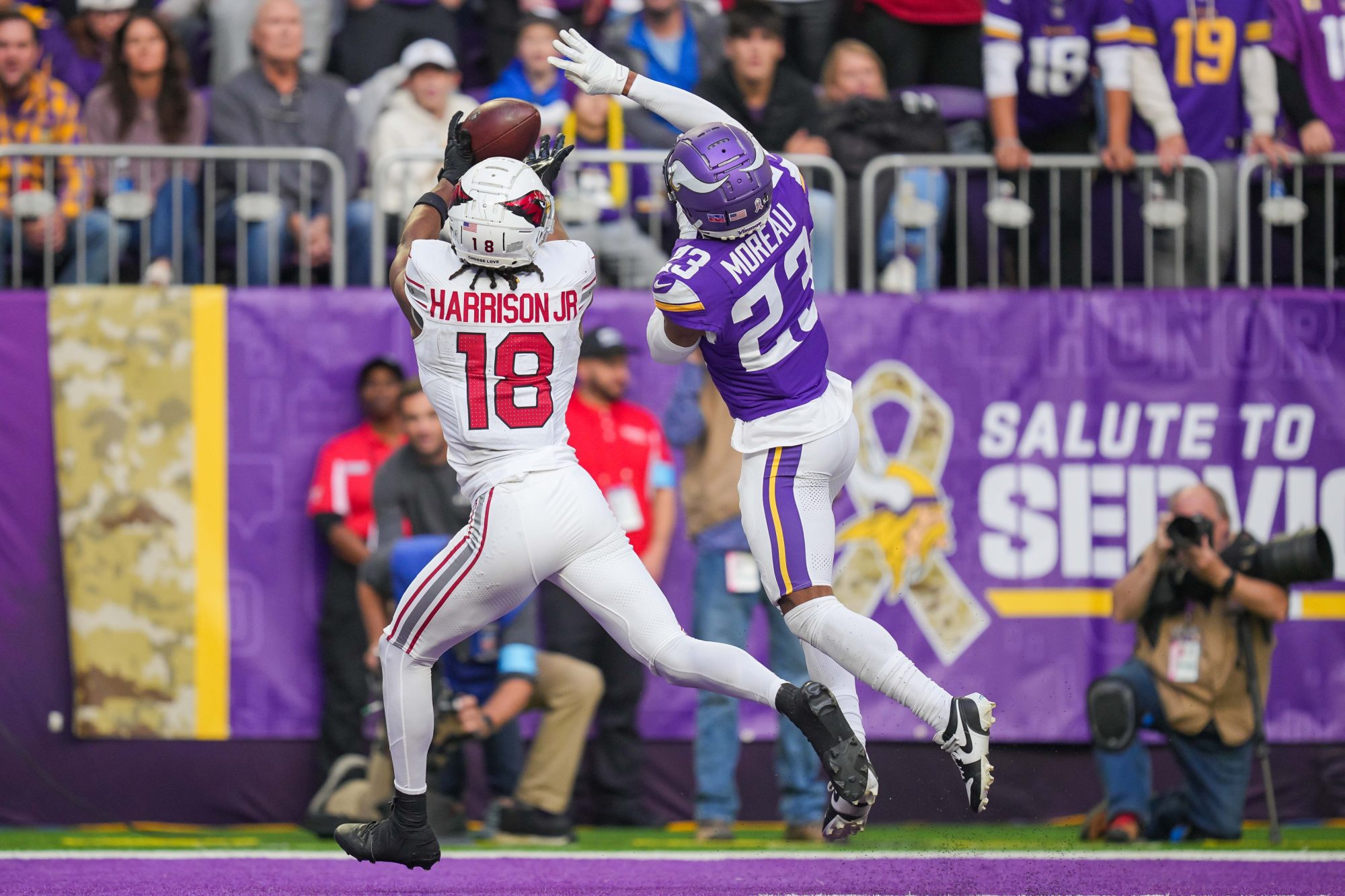 Dec 1, 2024; Minneapolis, Minnesota, USA; Arizona Cardinals wide receiver Marvin Harrison Jr. (18) catches a pass for a touchdown against the Minnesota Vikings cornerback Fabian Moreau (23) in the third quarter at U.S. Bank Stadium.