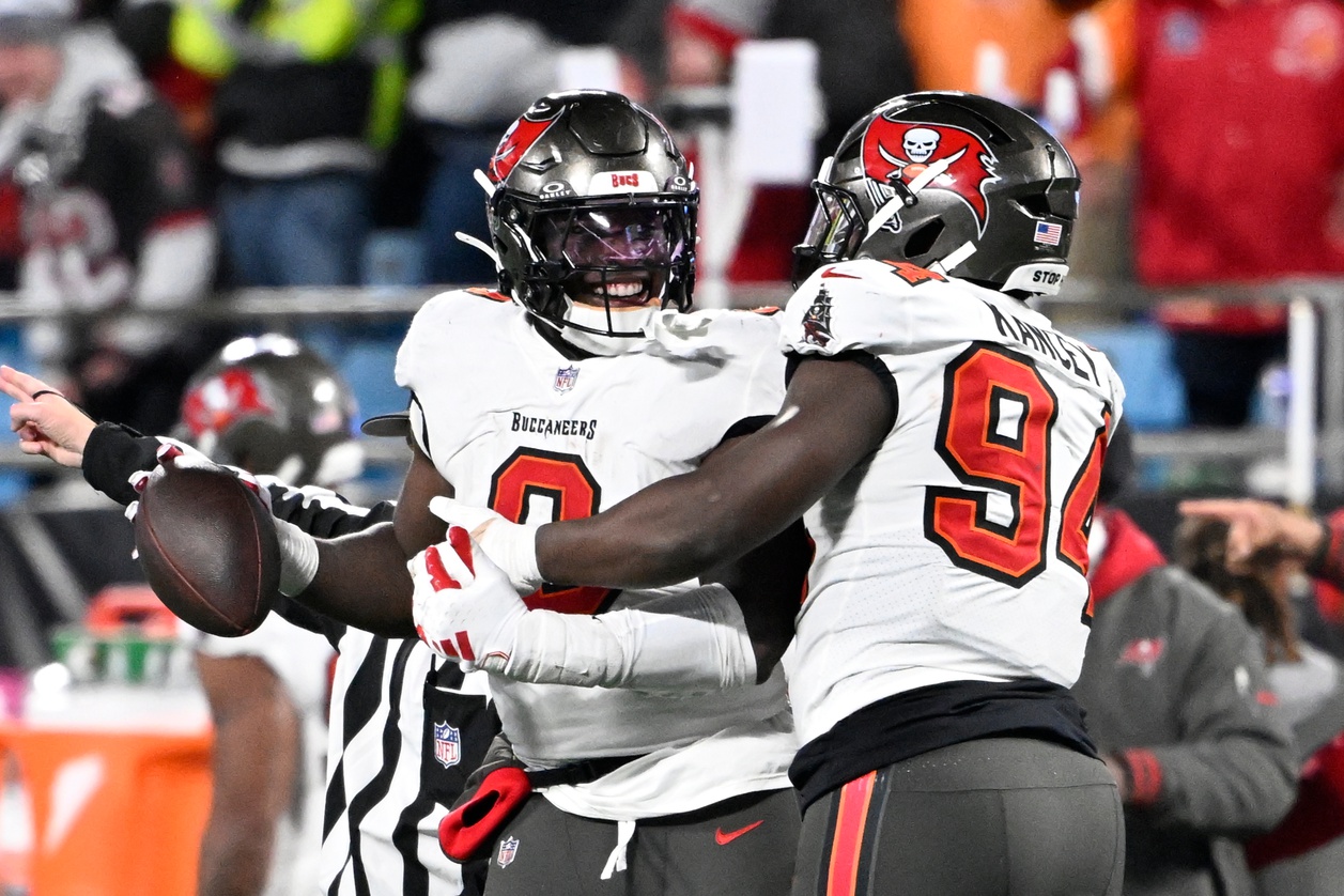 Dec 1, 2024; Charlotte, North Carolina, USA; Tampa Bay Buccaneers linebacker Yaya Diaby (0) celebrates with defensive tackle Calijah Kancey (94) after recovering a fumble in overtime in overtime at Bank of America Stadium.