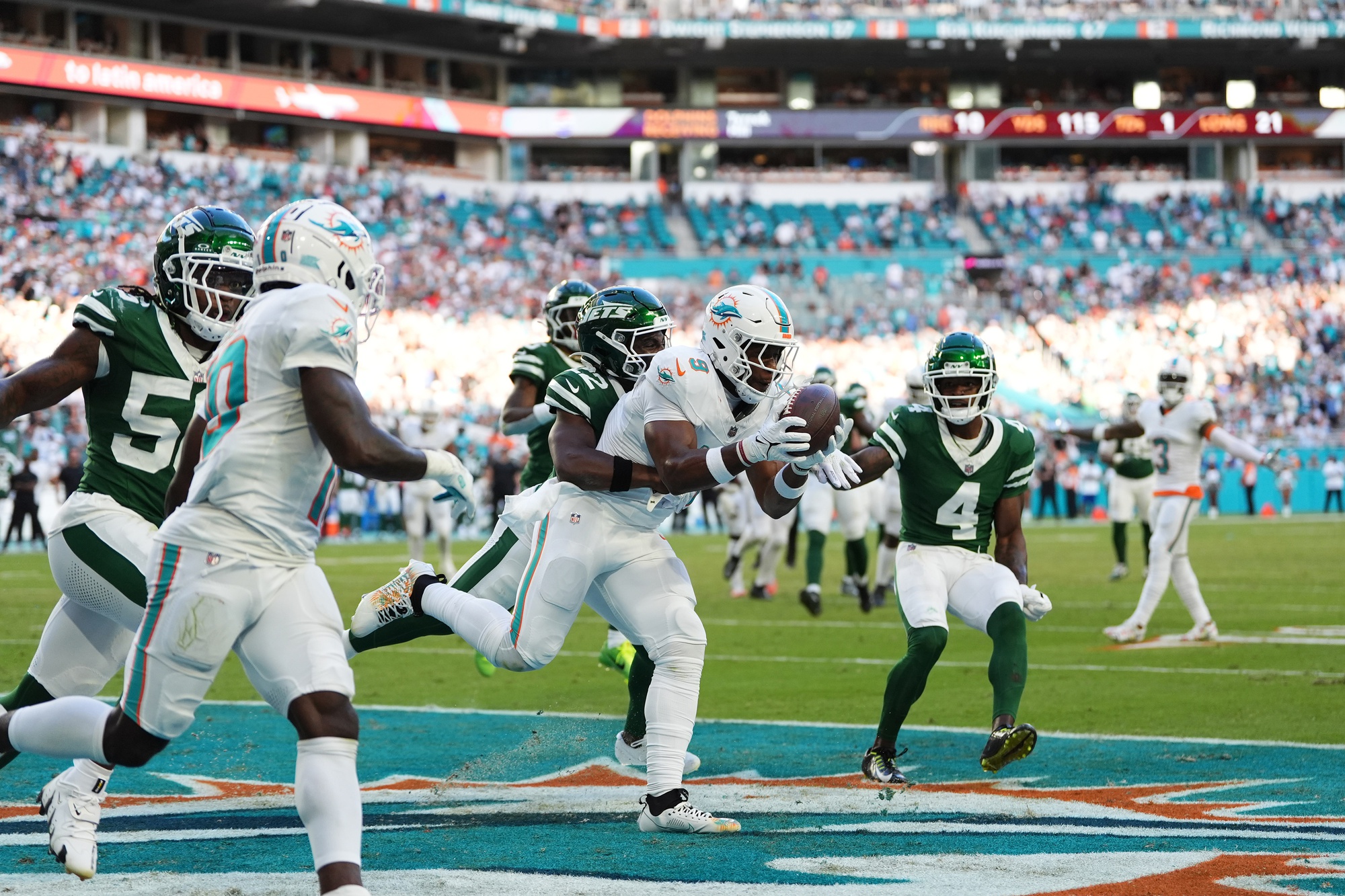 Dec 8, 2024; Miami Gardens, Florida, USA; Miami Dolphins tight end Jonnu Smith (9) makes a catch for the game winning touchdown during overtime against the New York Jets at Hard Rock Stadium.