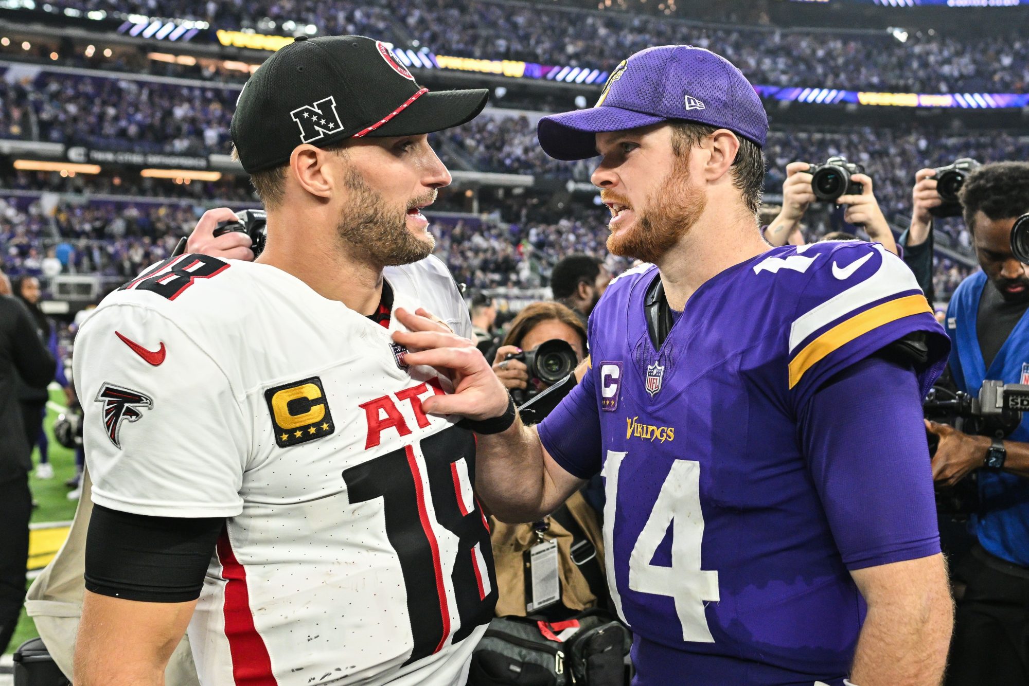 Dec 8, 2024; Minneapolis, Minnesota, USA; Atlanta Falcons quarterback Kirk Cousins (18) and Minnesota Vikings quarterback Sam Darnold (14) talk after the game at U.S. Bank Stadium.