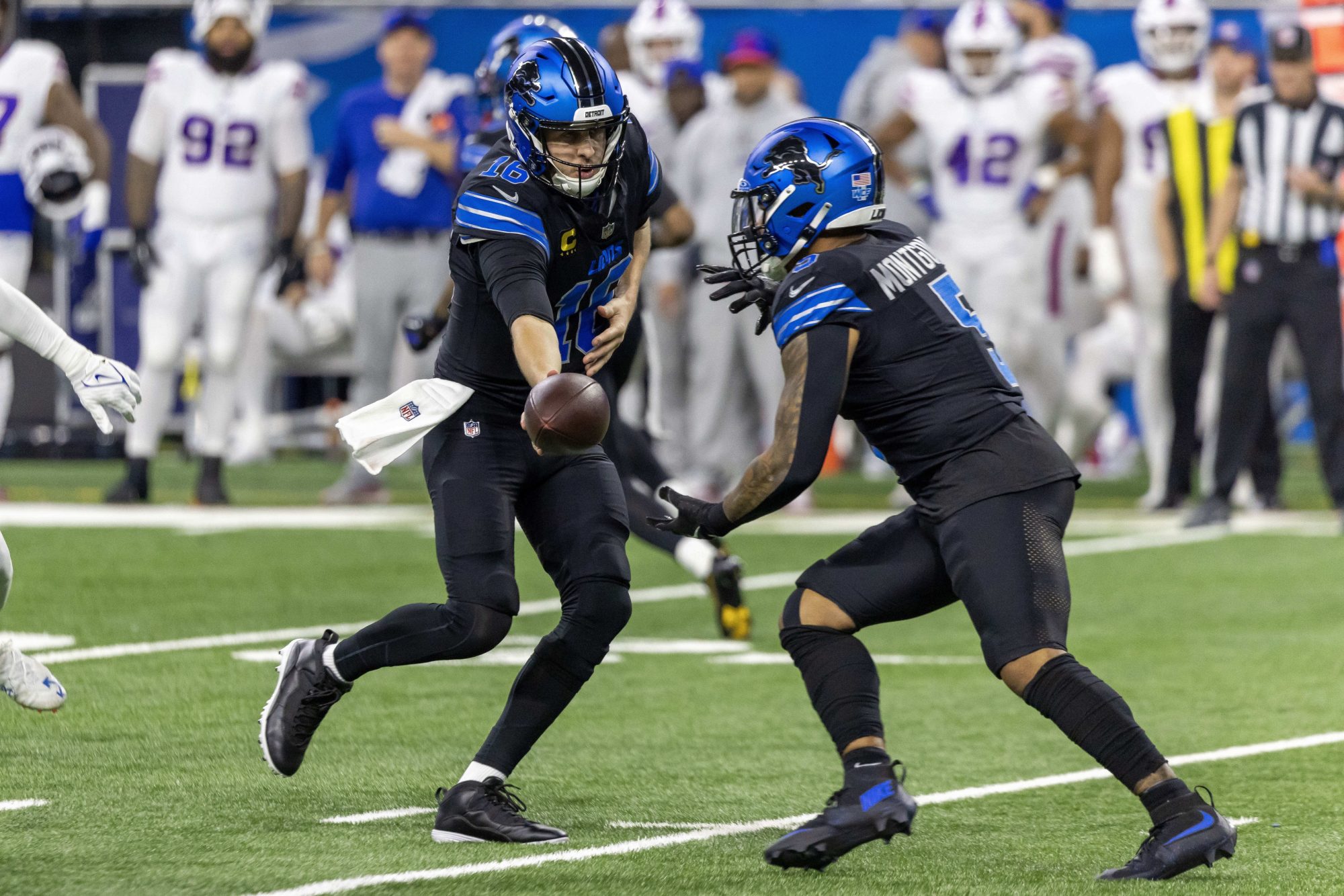 Dec 15, 2024; Detroit, Michigan, USA; Detroit Lions quarterback Jared Goff (16) hands off to running back David Montgomery (5) during the first quarter against the Buffalo Bills at Ford Field.