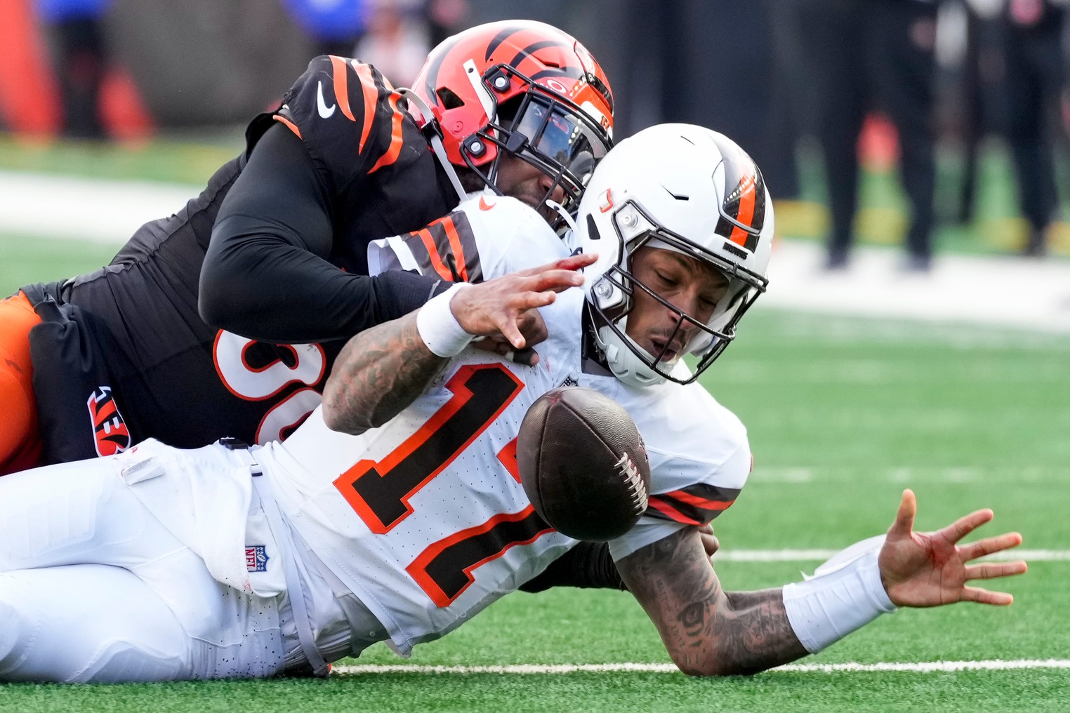 Cleveland Browns quarterback Dorian Thompson-Robinson (17) recovers his own fumble as he’s tackled by Cincinnati Bengals defensive end Joseph Ossai (58) in the fourth quarter of the NFL Week 16 game between the Cincinnati Bengals and the Cleveland Browns at Paycor Stadium in downtown Cincinnati on Sunday, Dec. 22, 2024. The Bengals won 24-16.