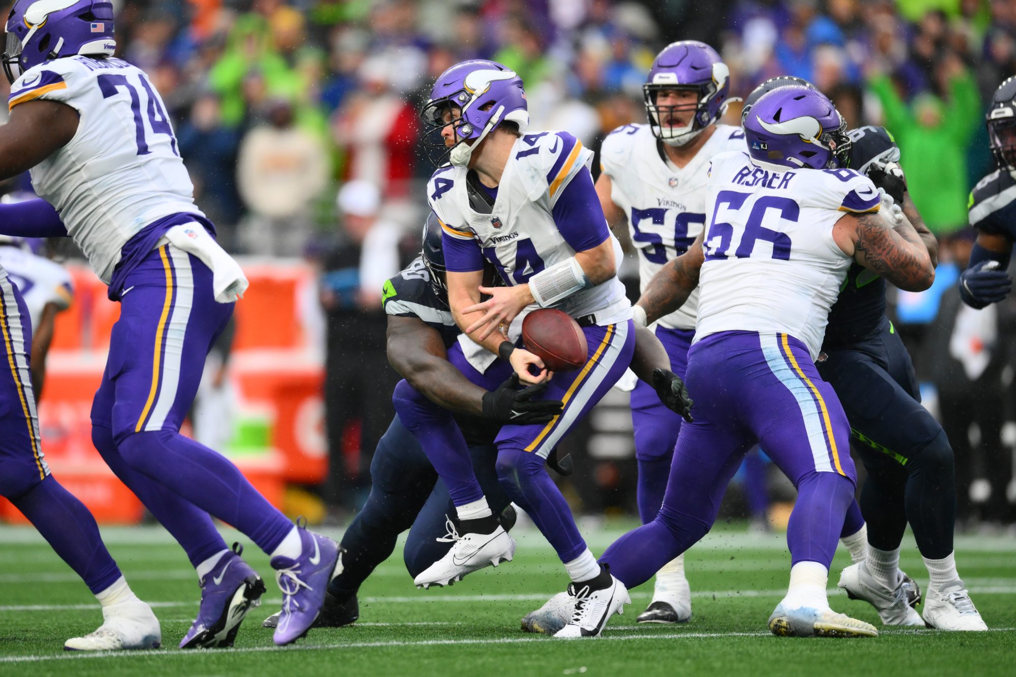 Dec 22, 2024; Seattle, Washington, USA; Seattle Seahawks defensive tackle Jarran Reed (90) sacks Minnesota Vikings quarterback Sam Darnold (14) during the first half at Lumen Field.