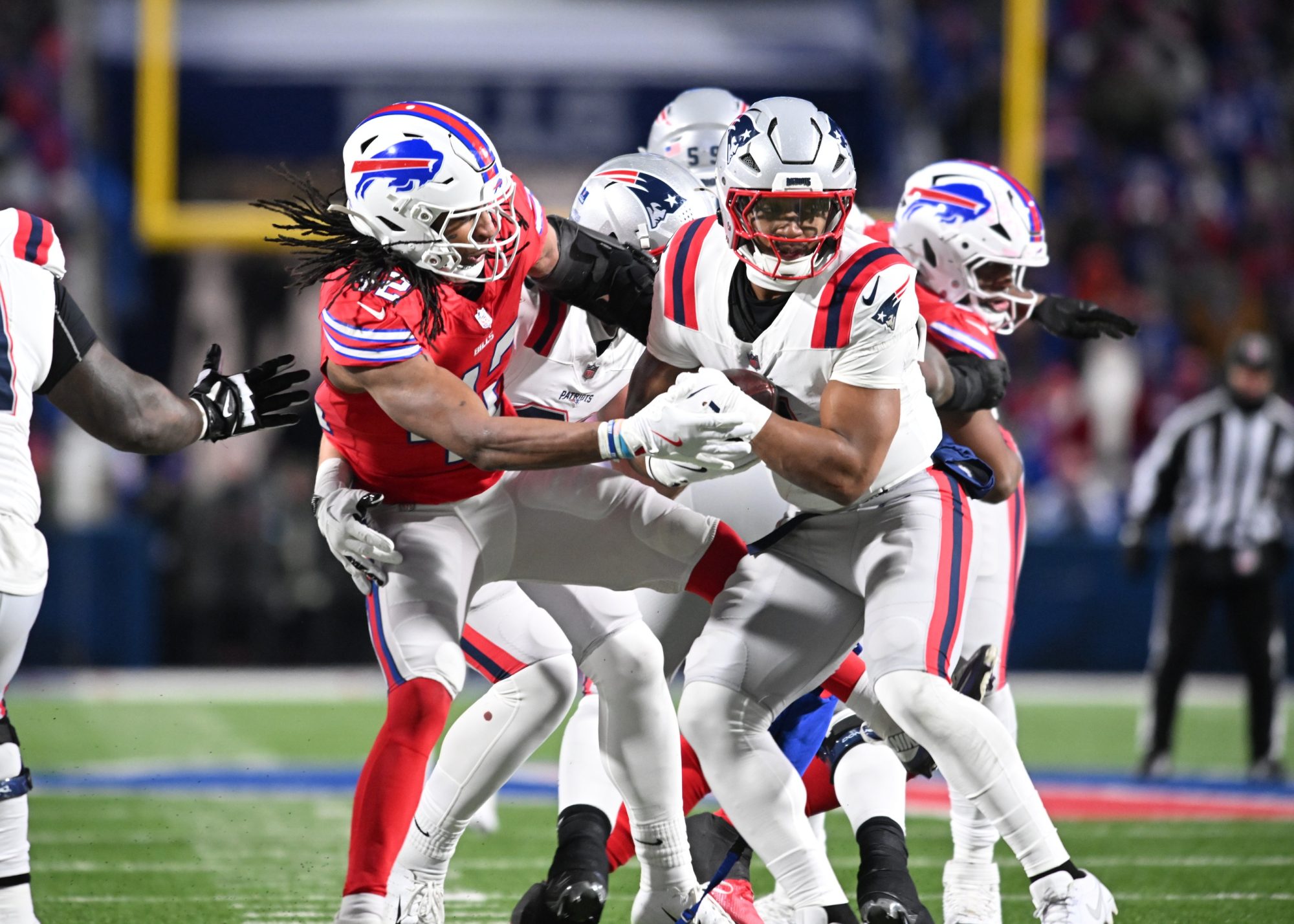 Dec 22, 2024; Orchard Park, New York, USA; Buffalo Bills linebacker Dorian Williams (42) tries to strip the ball from New England Patriots running back Antonio Gibson (4) in the second quarter at Highmark Stadium.