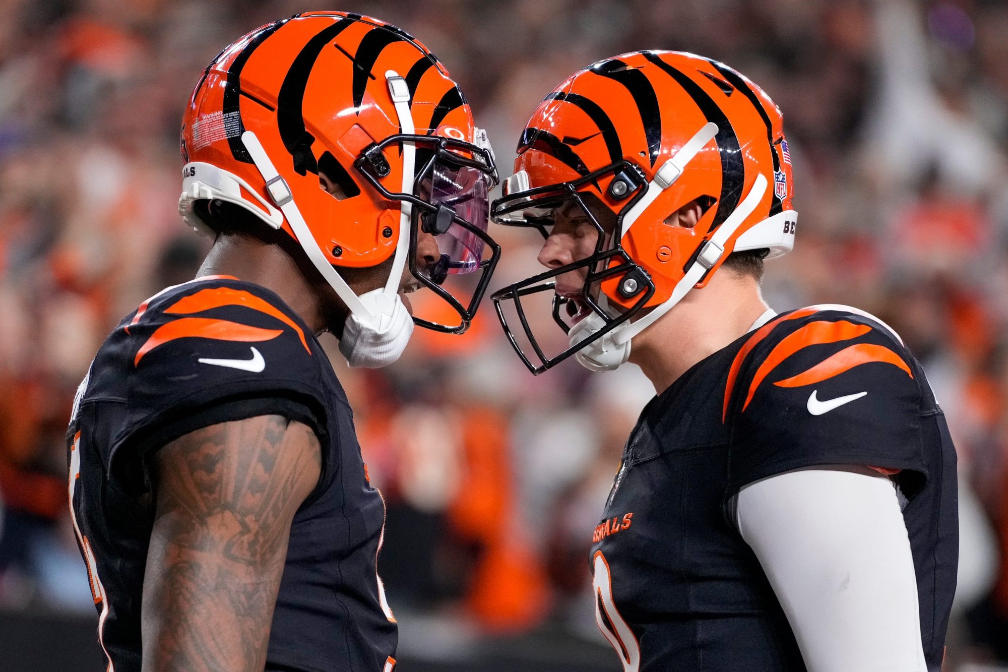 Bengals wide receiver Tee Higgins (5) and quarterback Joe Burrow (9) celebrate a touchdown in the fourth quarter against the Broncos at Paycor Stadium on Saturday, Dec. 28, 2024.