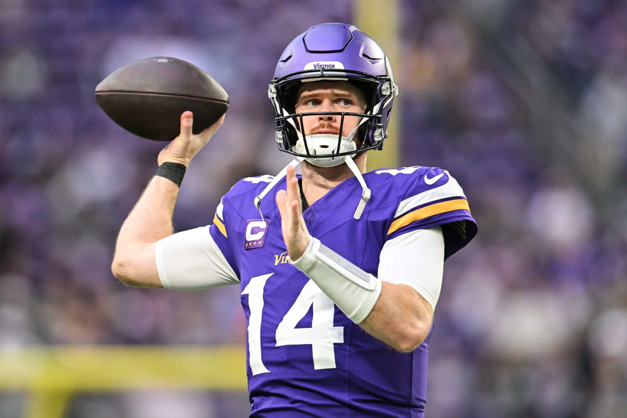 Dec 29, 2024; Minneapolis, Minnesota, USA; Minnesota Vikings quarterback Sam Darnold (14) warms up before the game against the Green Bay Packers at U.S. Bank Stadium.