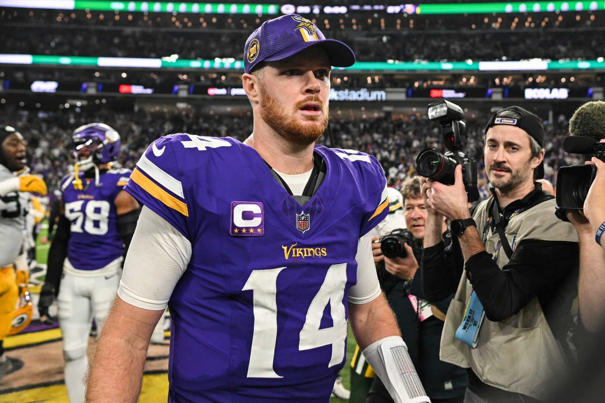 Dec 29, 2024; Minneapolis, Minnesota, USA; Minnesota Vikings quarterback Sam Darnold (14) walks off the field after the game against the Green Bay Packers at U.S. Bank Stadium.