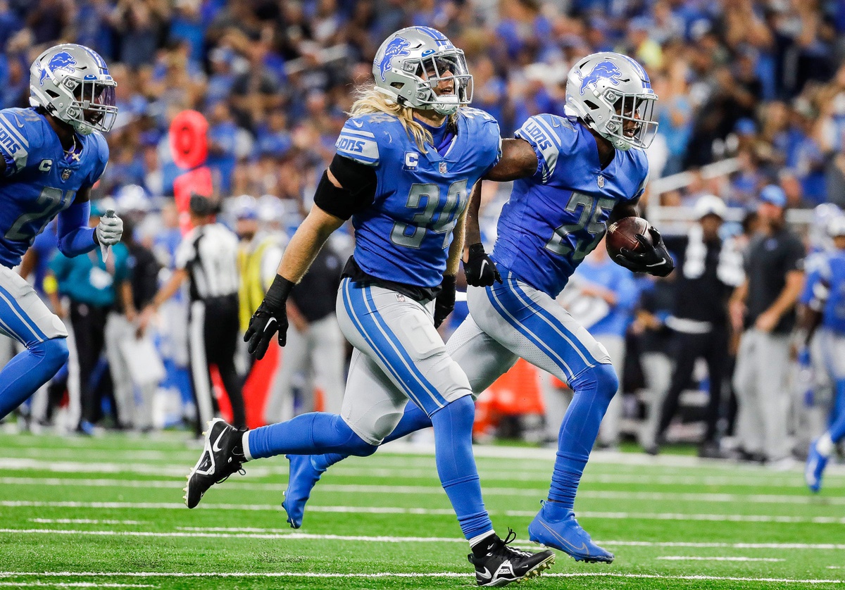 Sep 18, 2022; Detroit, Michigan, USA; Detroit Lions safety Will Harris (25) and linebacker Alex Anzalone (34) run across the field to celebrate a play against the Washington Commanders during the second half at Ford Field.