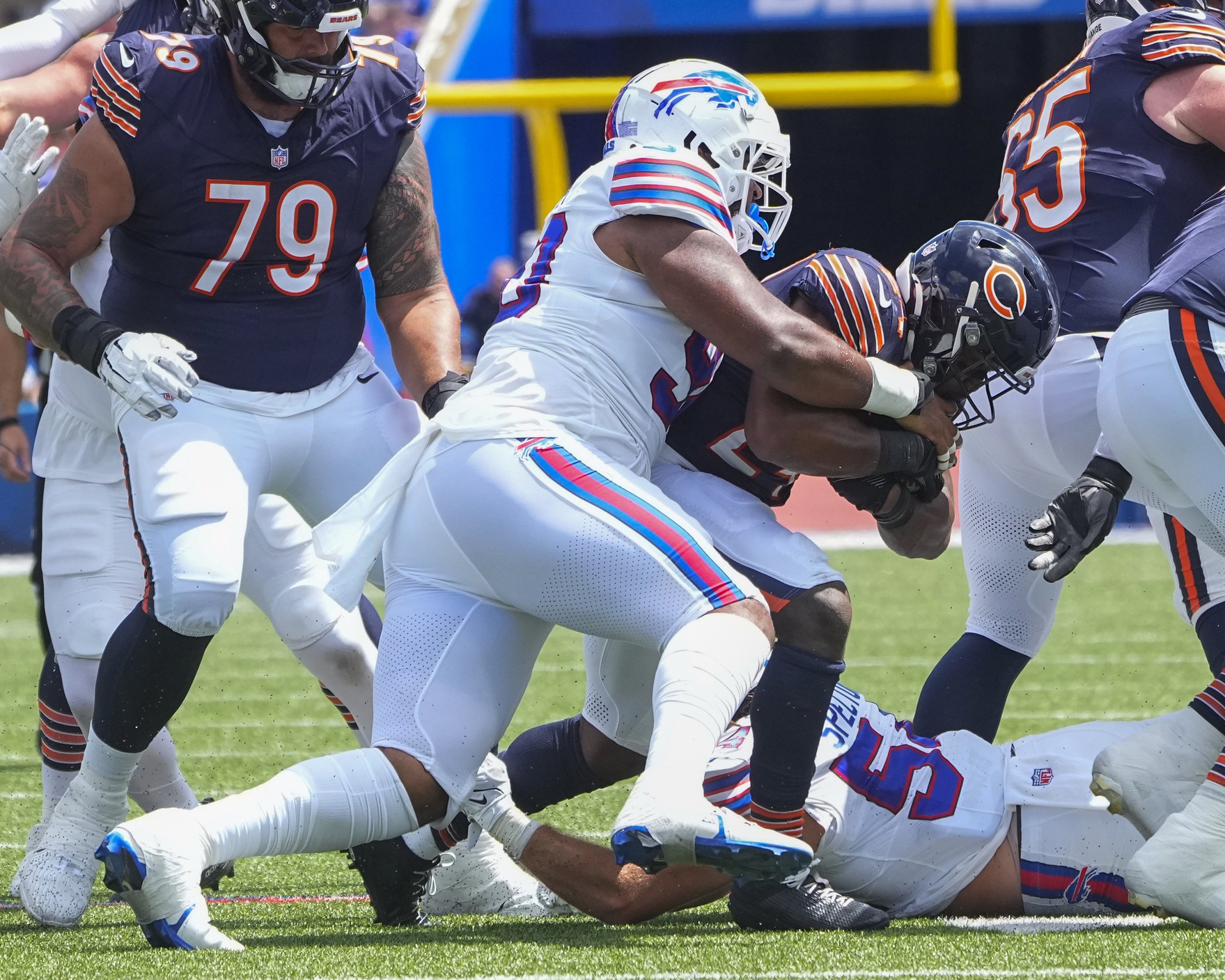 Aug 10, 2024; Orchard Park, New York, USA; Buffalo Bills defensive tackle DeWayne Carter (90) tackles Chicago Bears running back Khalil Herbert (24) during the first half at Highmark Stadium.